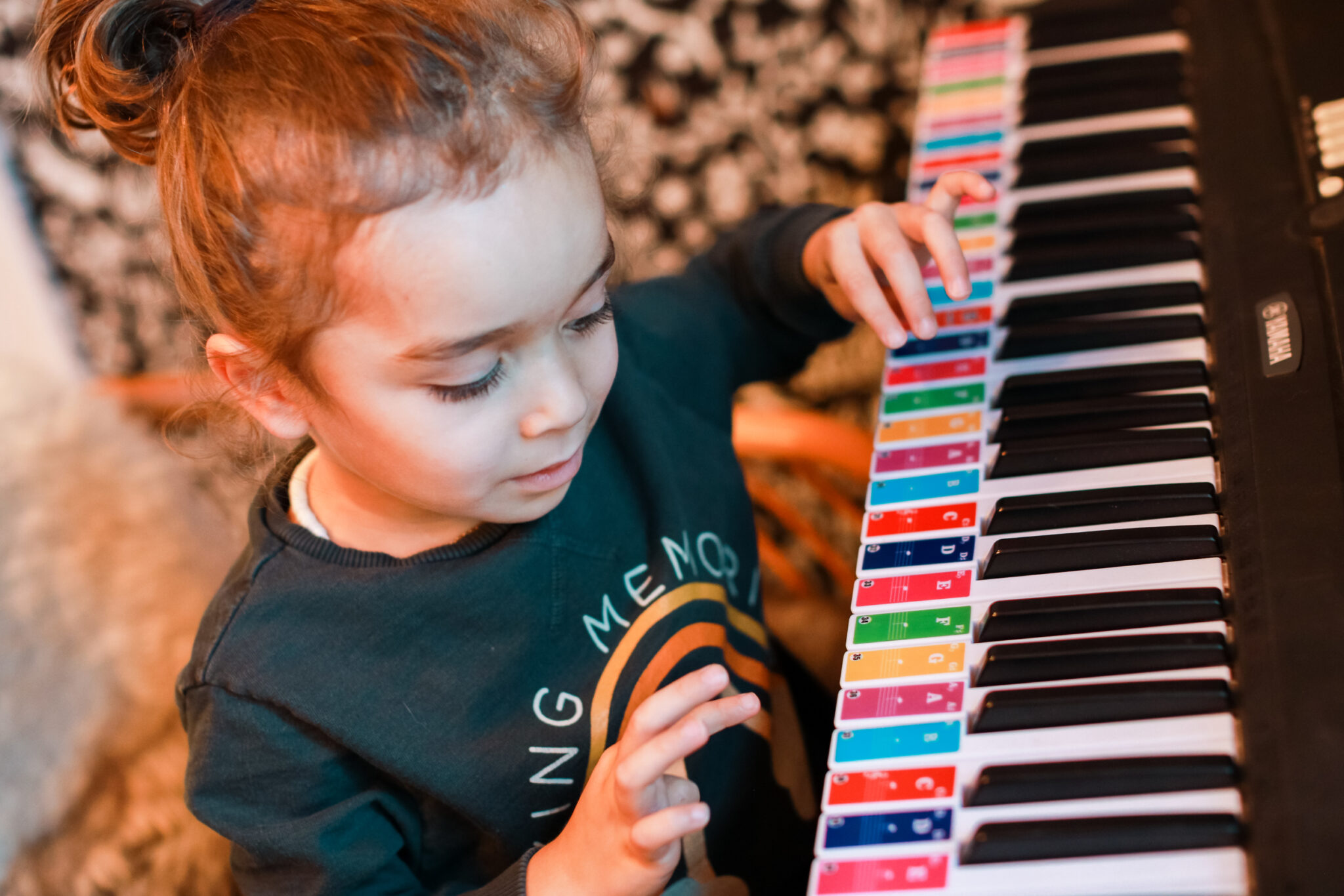 toddler learning how to play piano