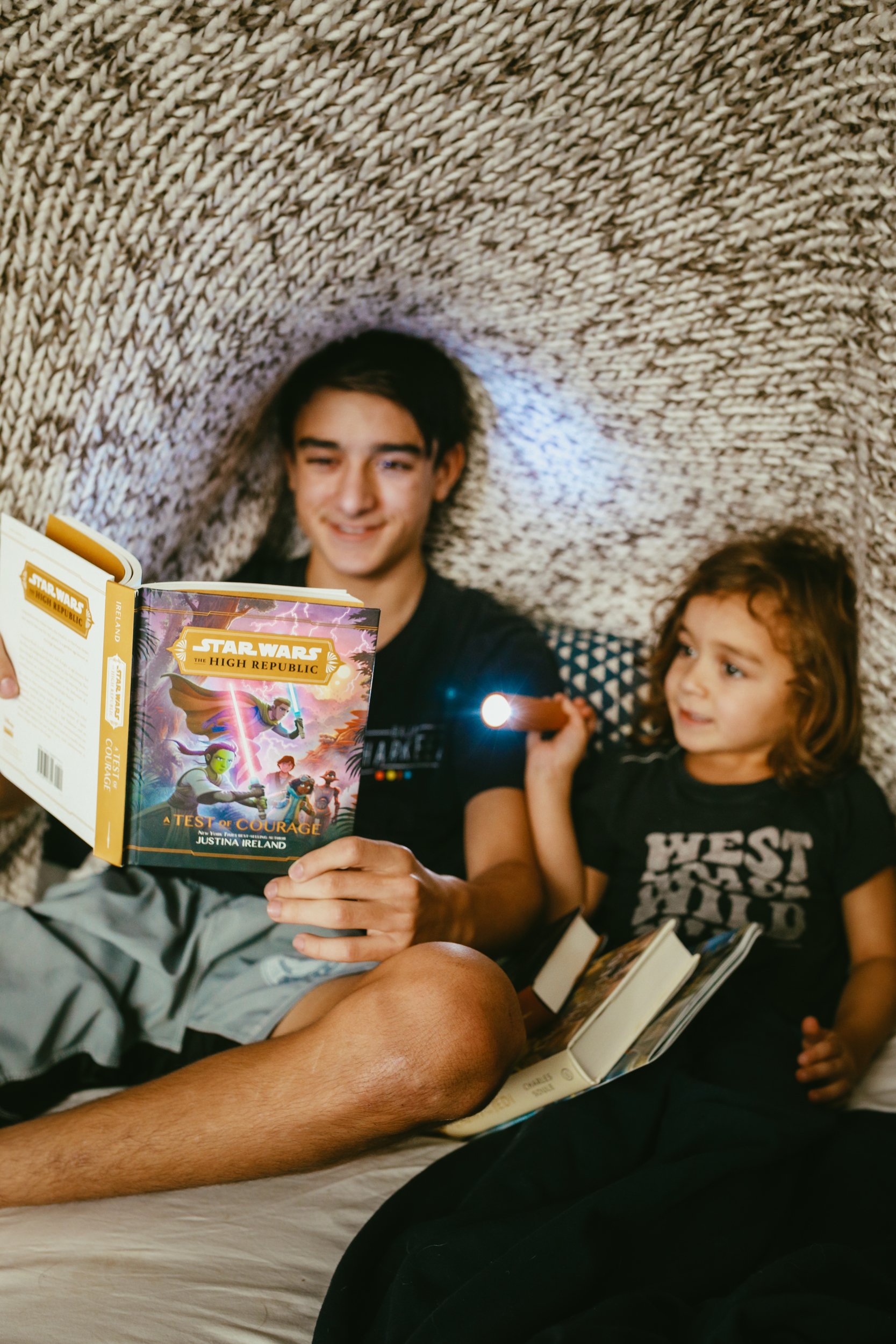 kids reading under a blanket