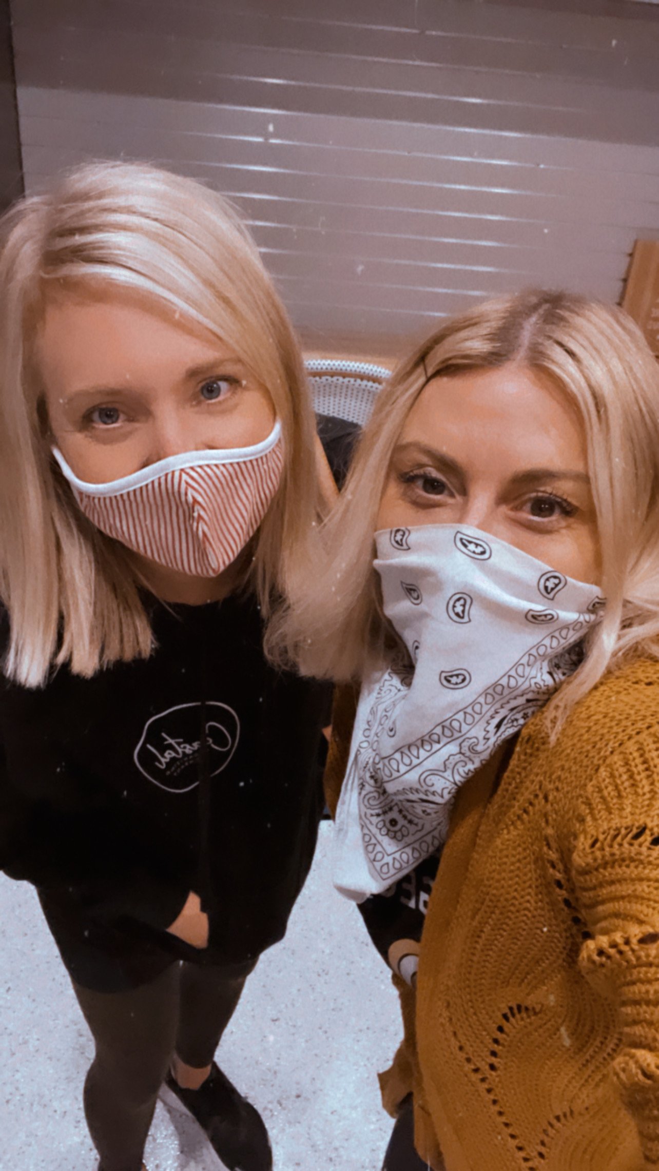 two women with face masks