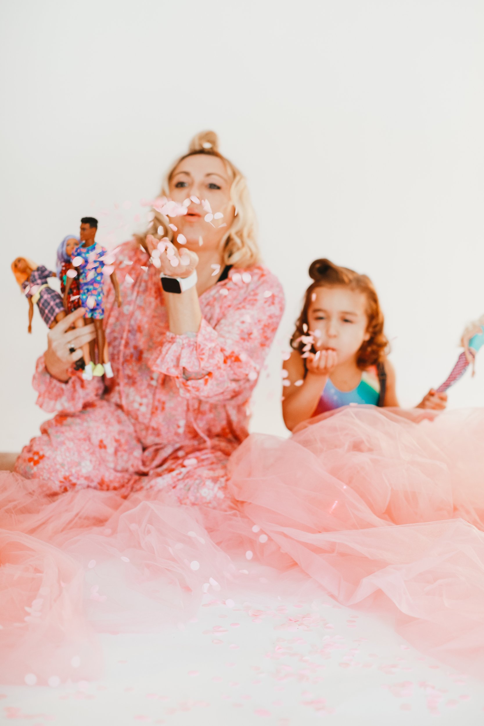 mom and child blowing petals