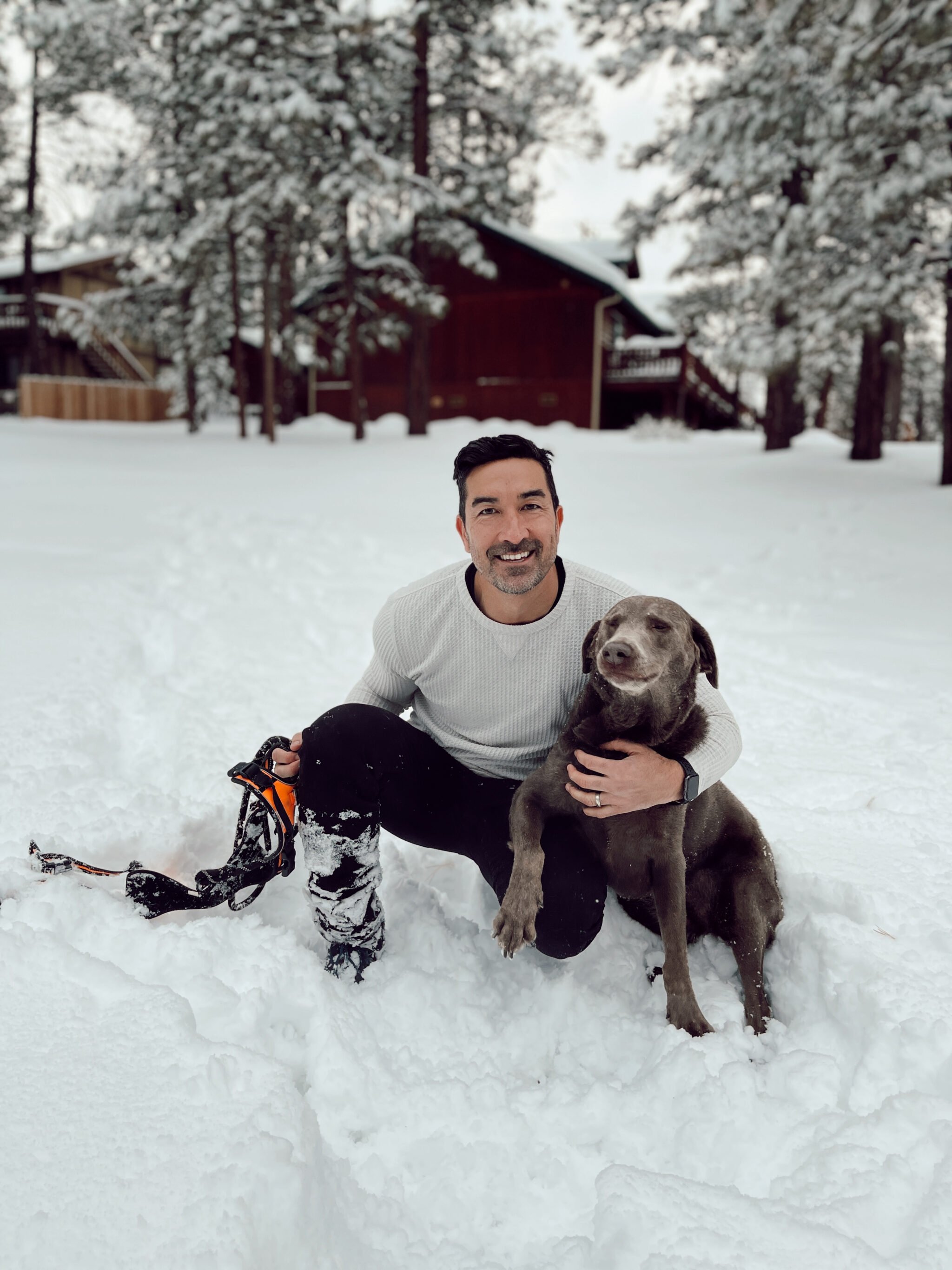 man and his dog in the snow