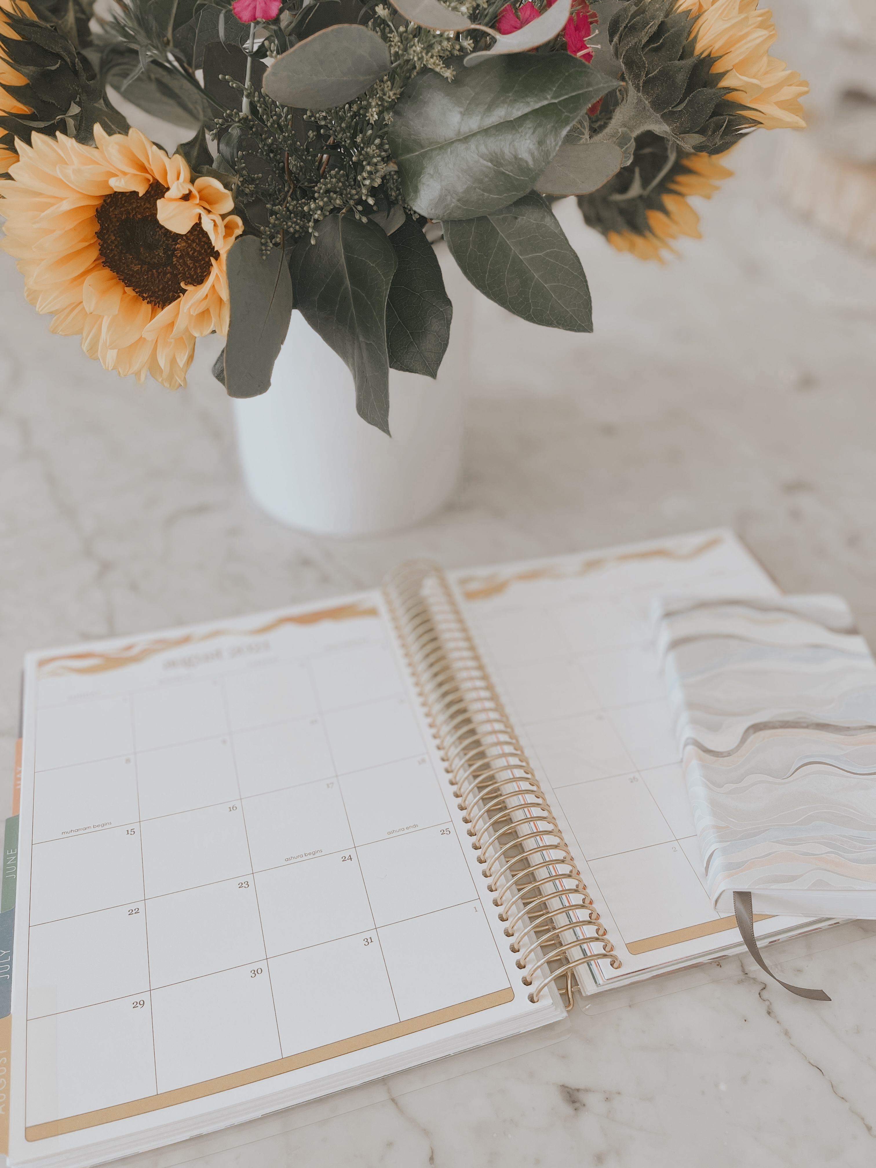 open planner on table with flowers