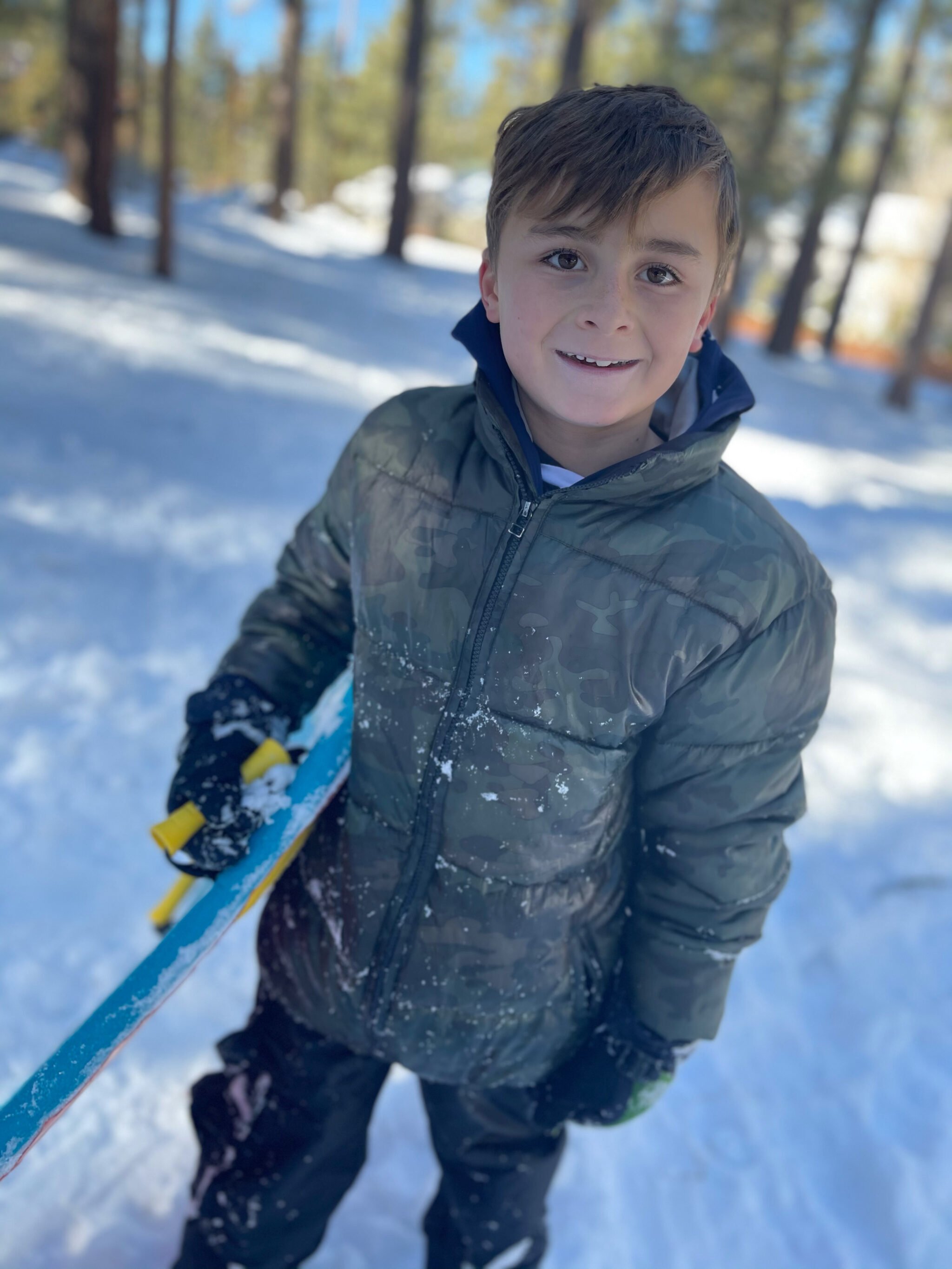 kid playing in the snow