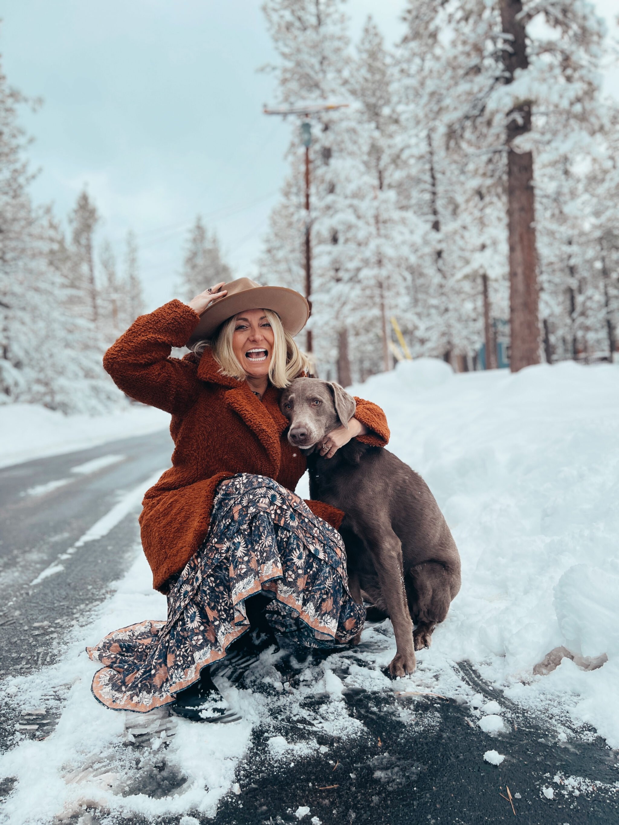 woman with her dog in the snow