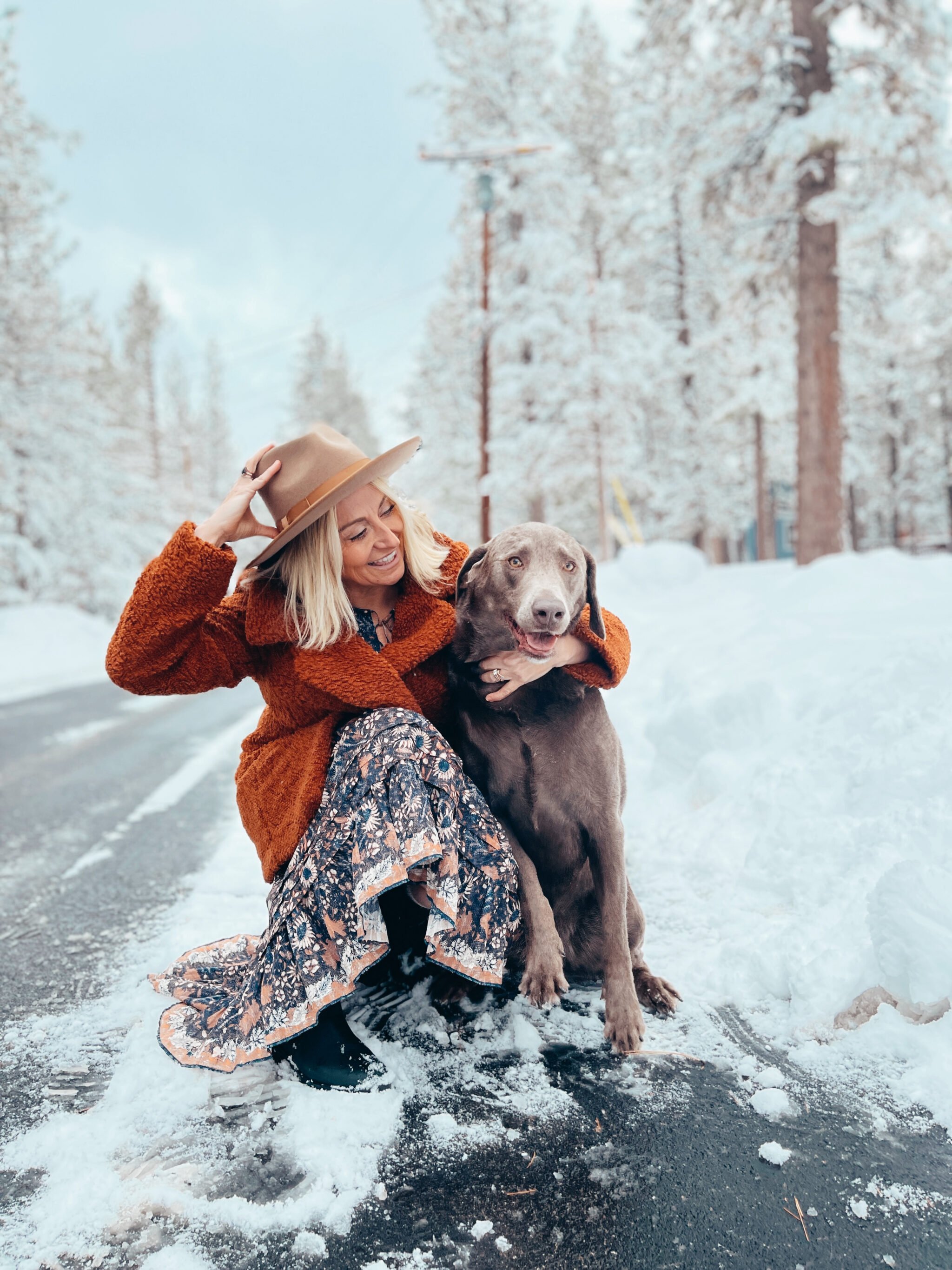 woman and dog in the snow