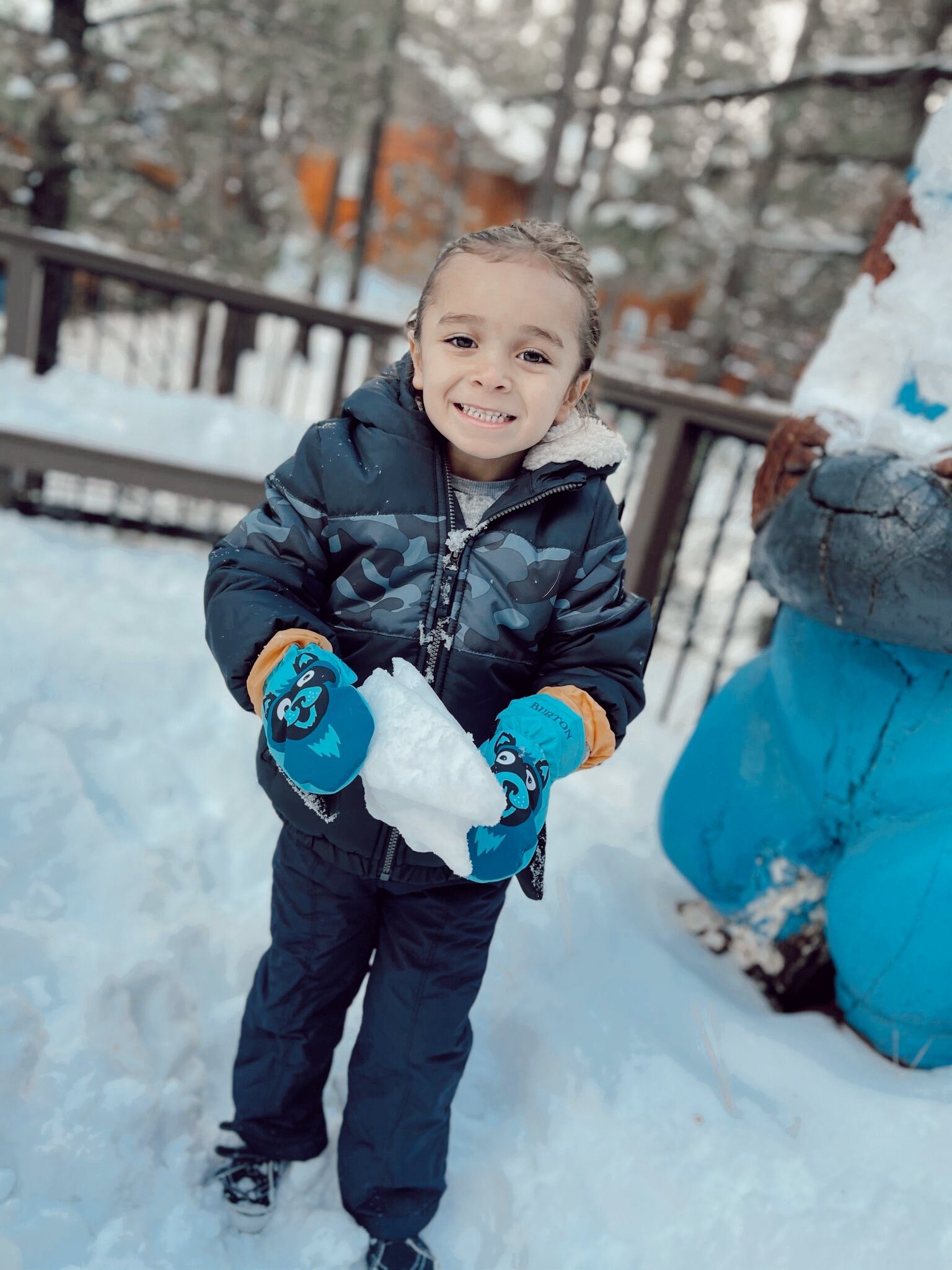 kid playing in the snow