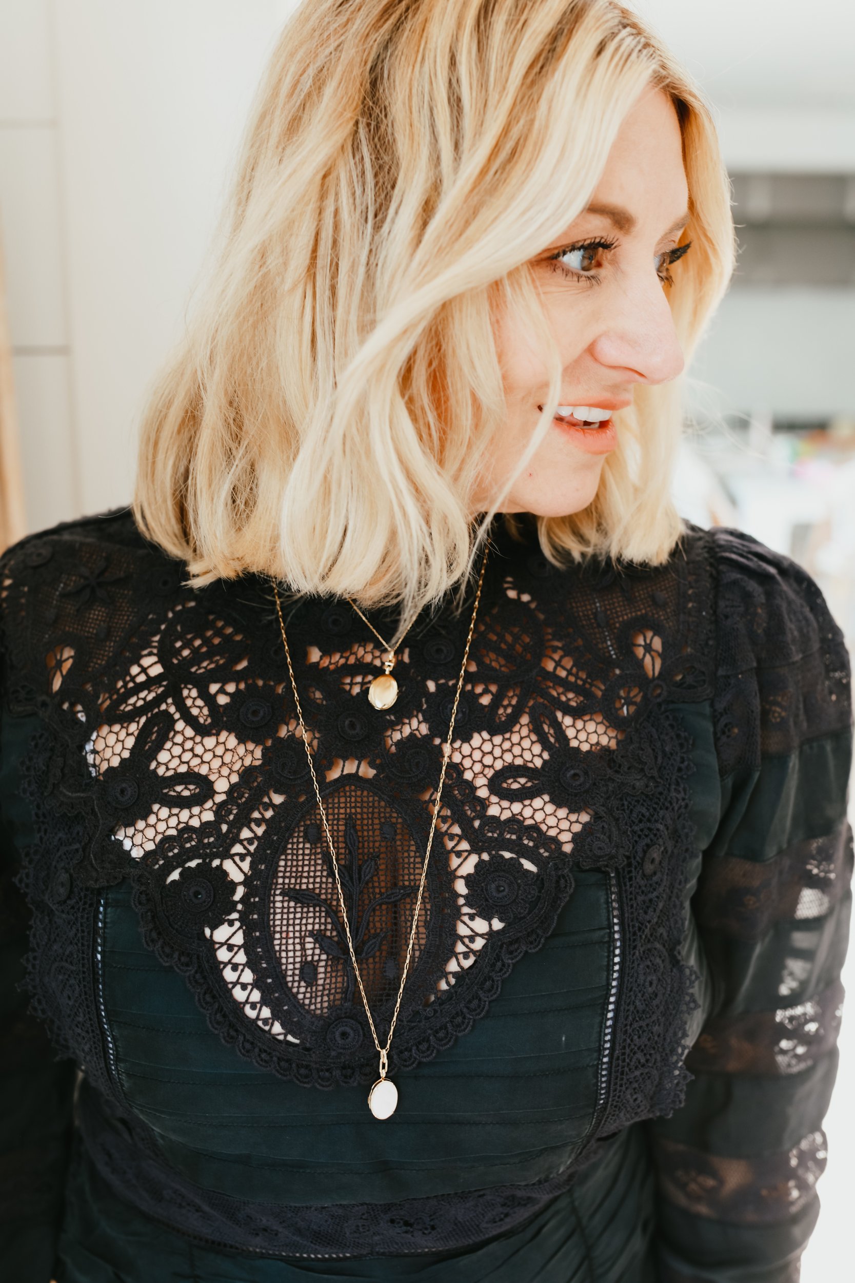 woman in black dress smiling