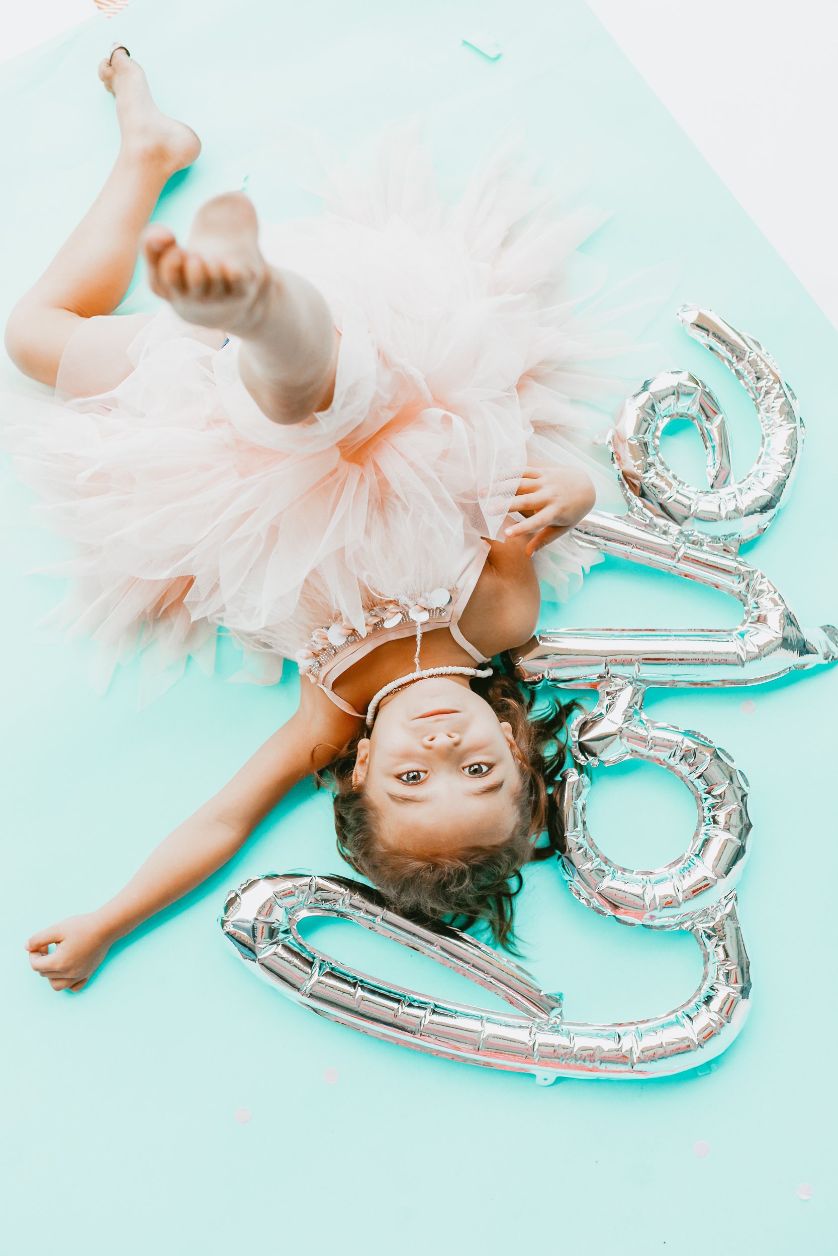 toddler with balloon and tutu