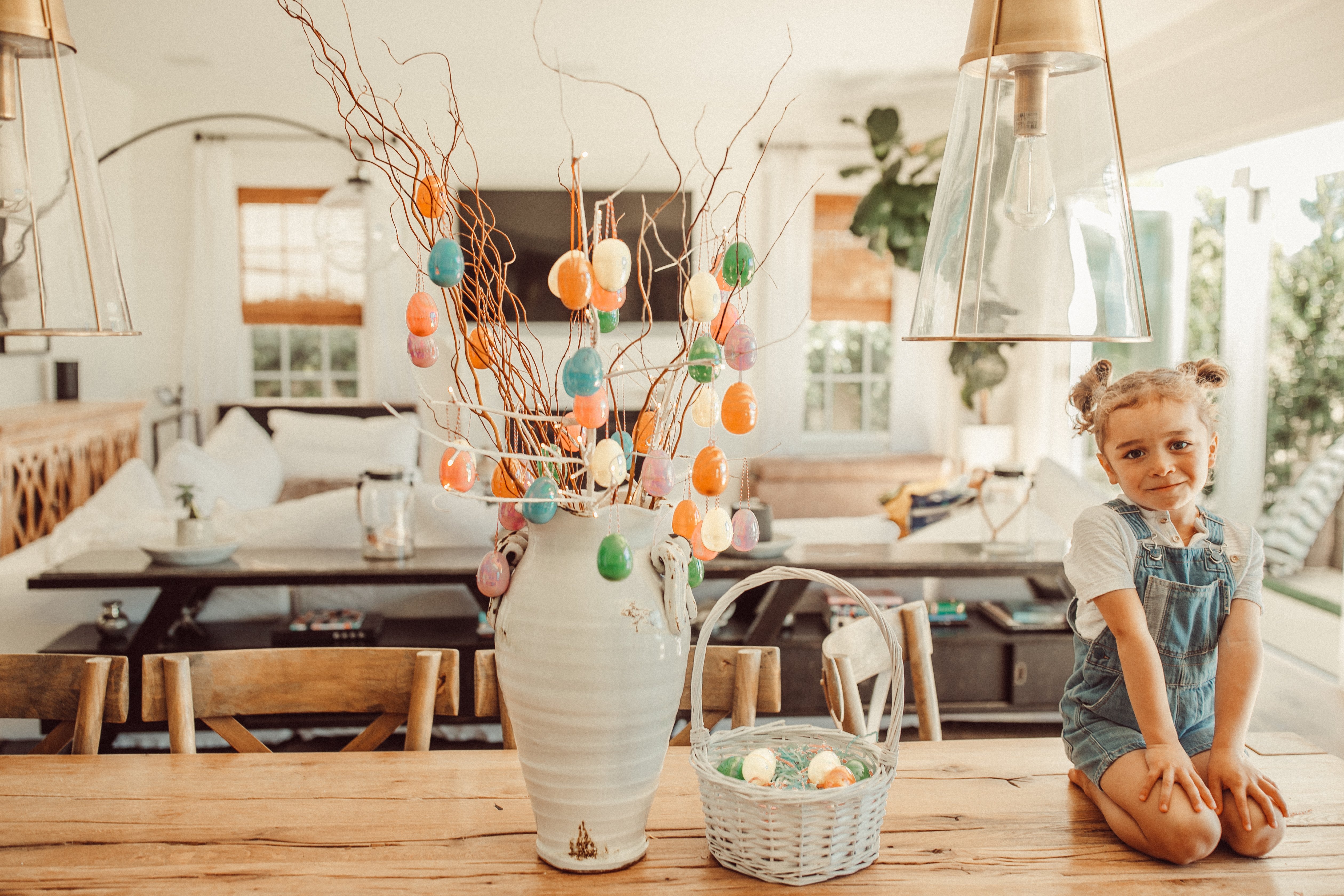 child on table with easter egg tree