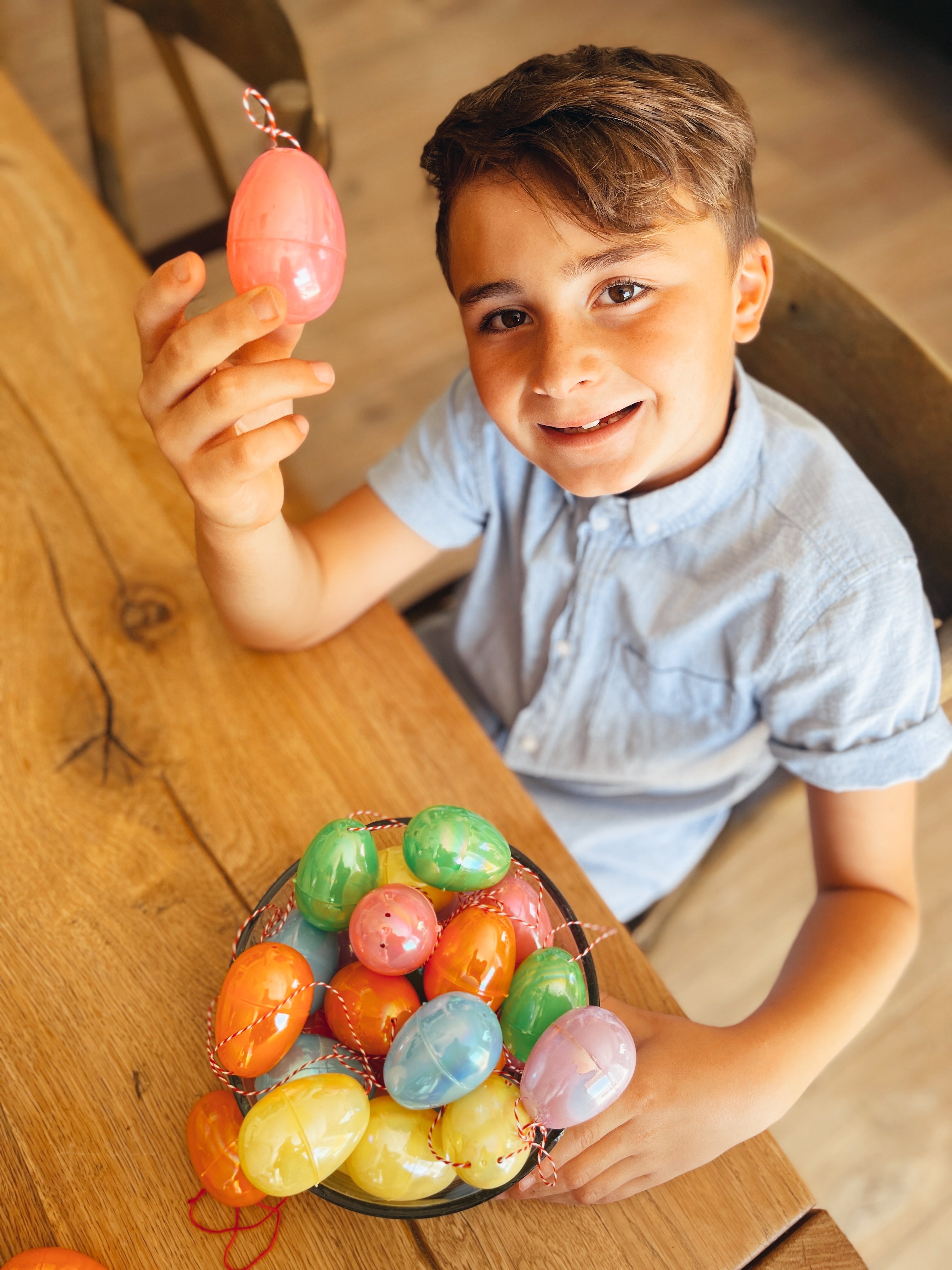 boy holding up easter eggs