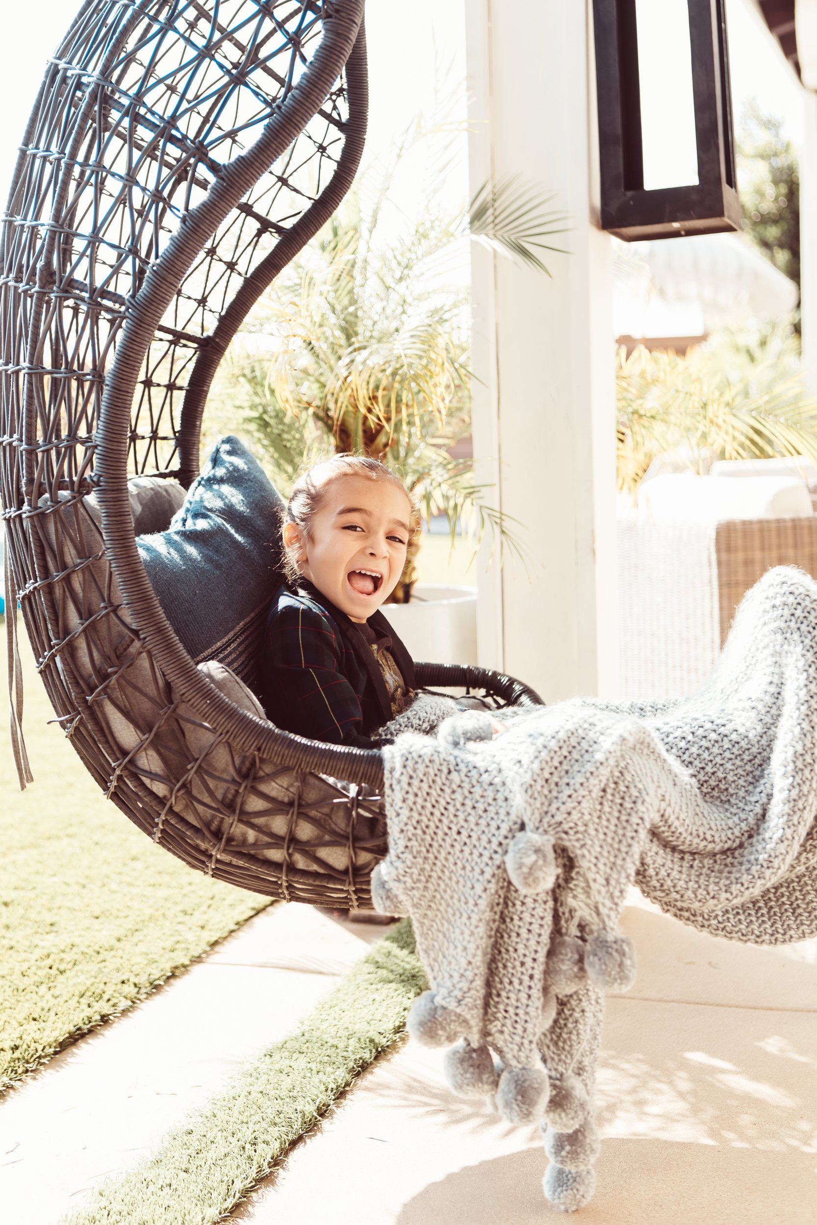 boy sitting in swinging chair