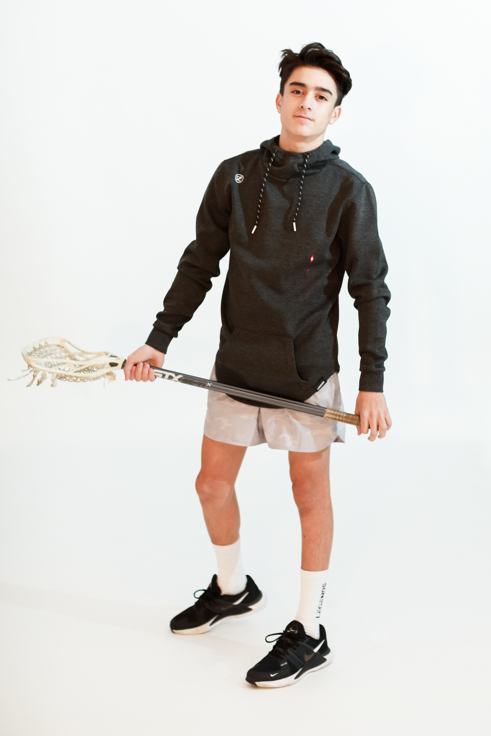 teen with his lacrosse gear