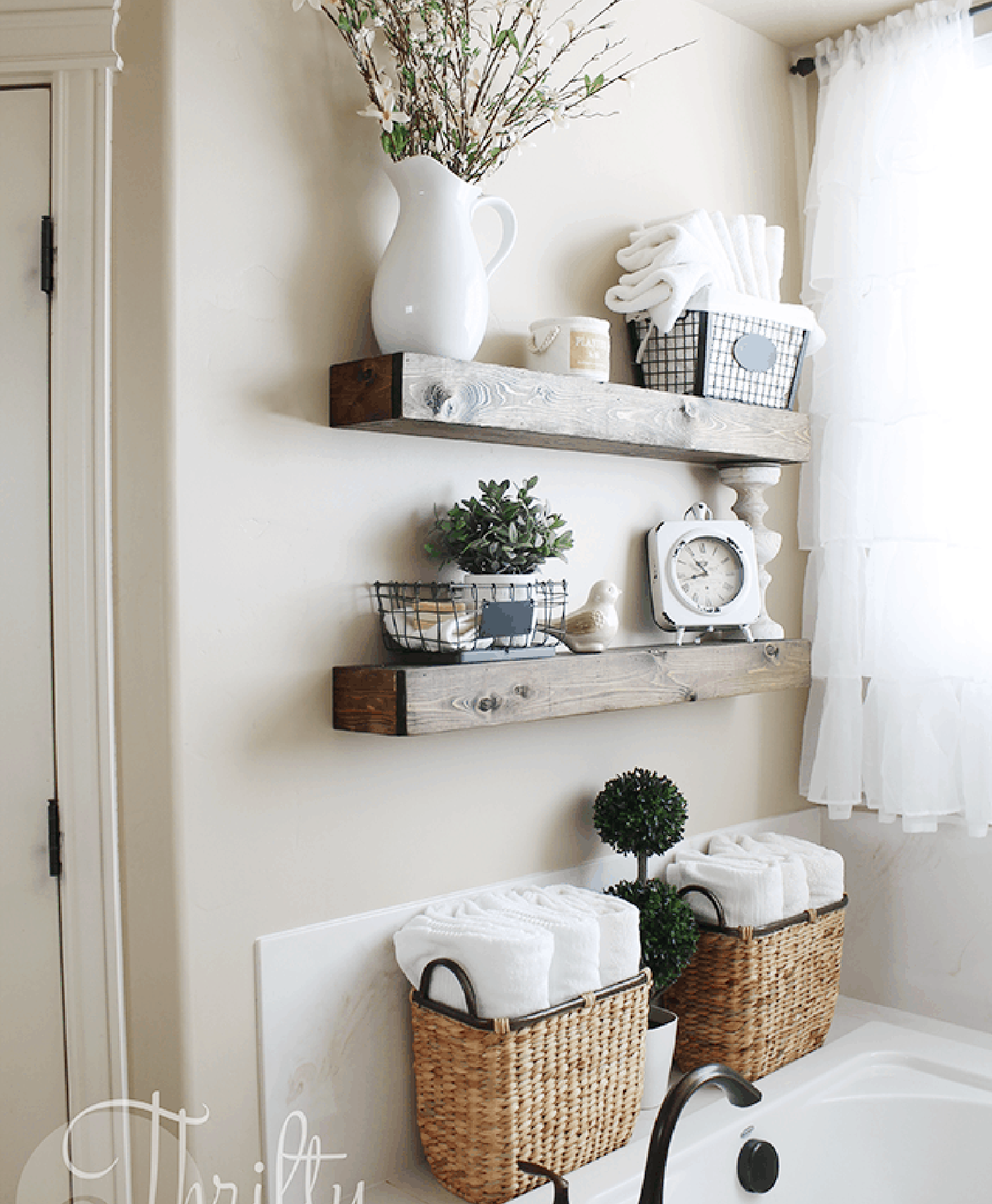 Floating wood shelves and woven baskets used for bathroom storage.