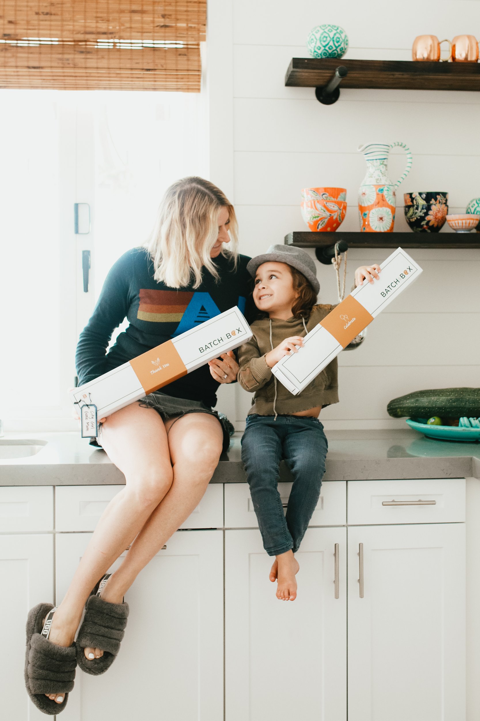 mom and kid holding cookie boxes