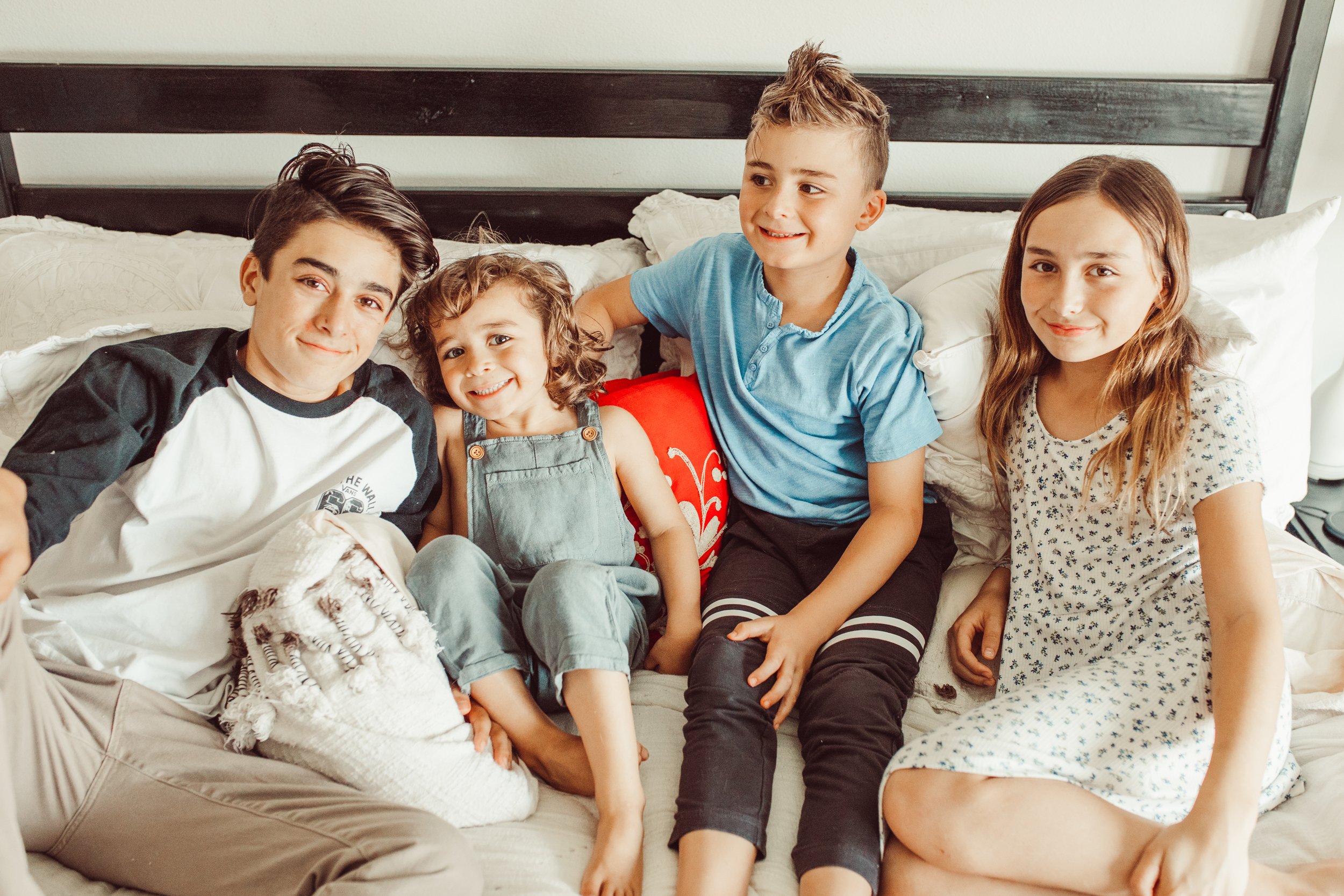 happy kids sitting on bed