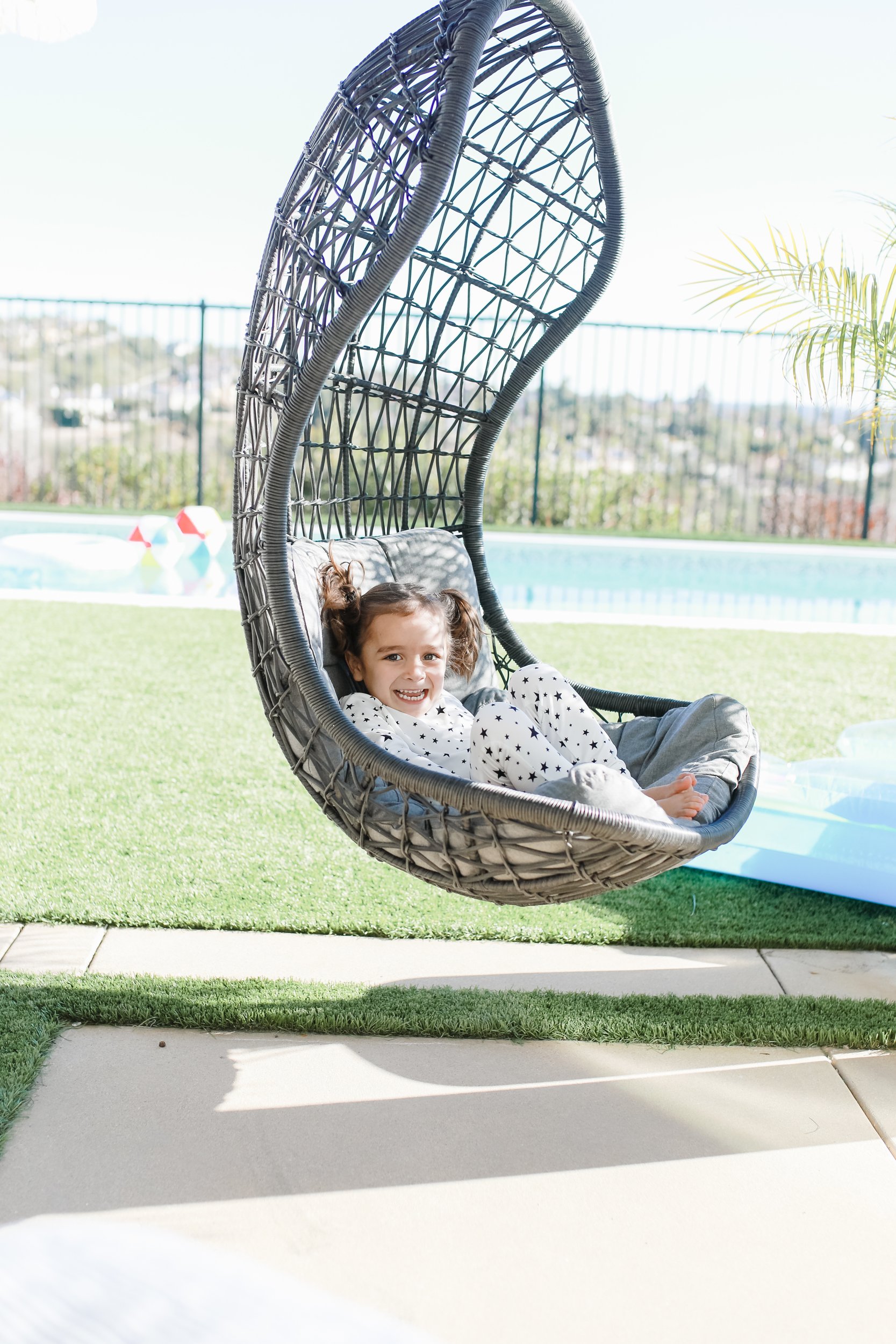 boy sitting in outdoor swing