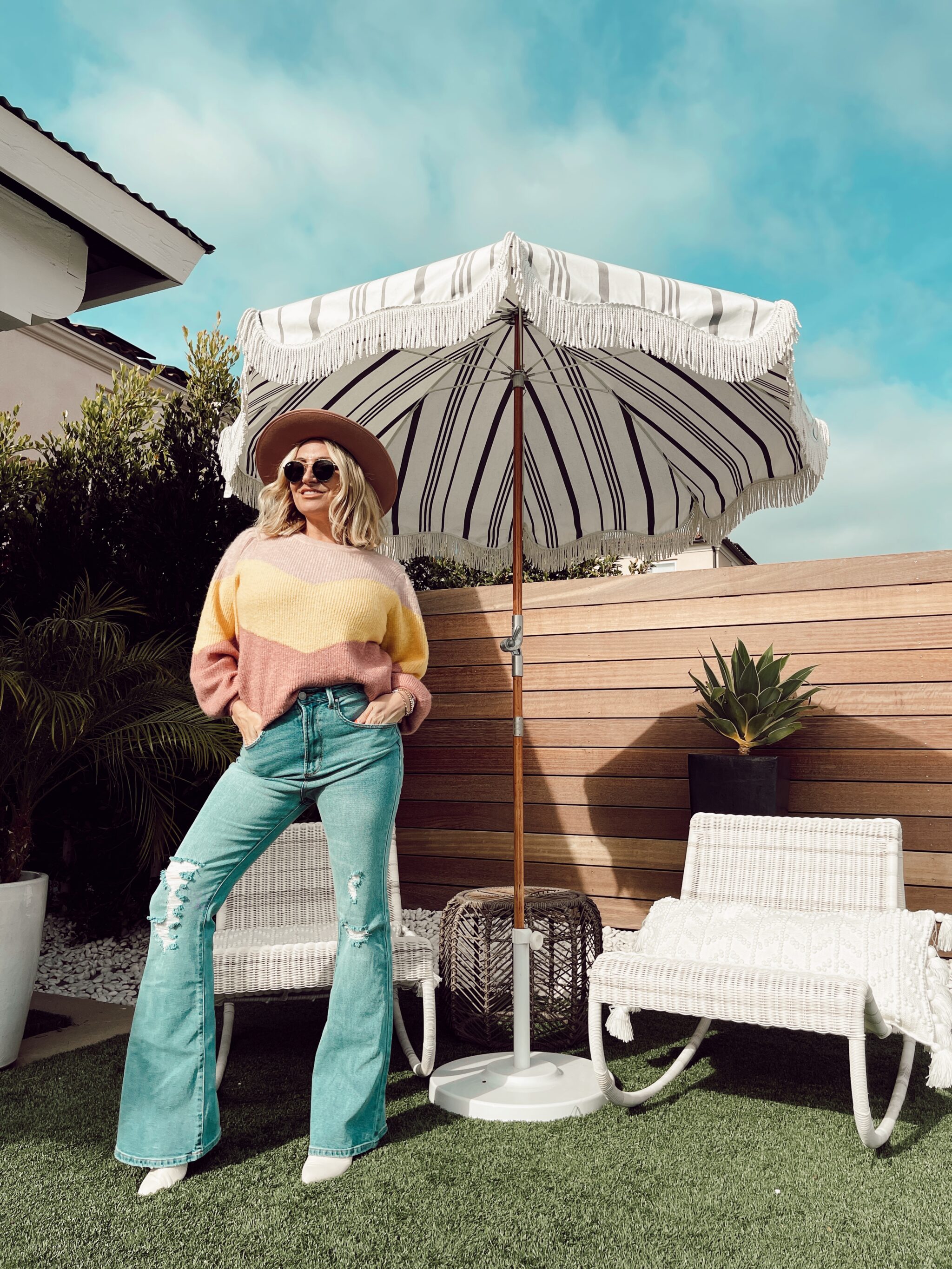 woman outside posing by umbrella