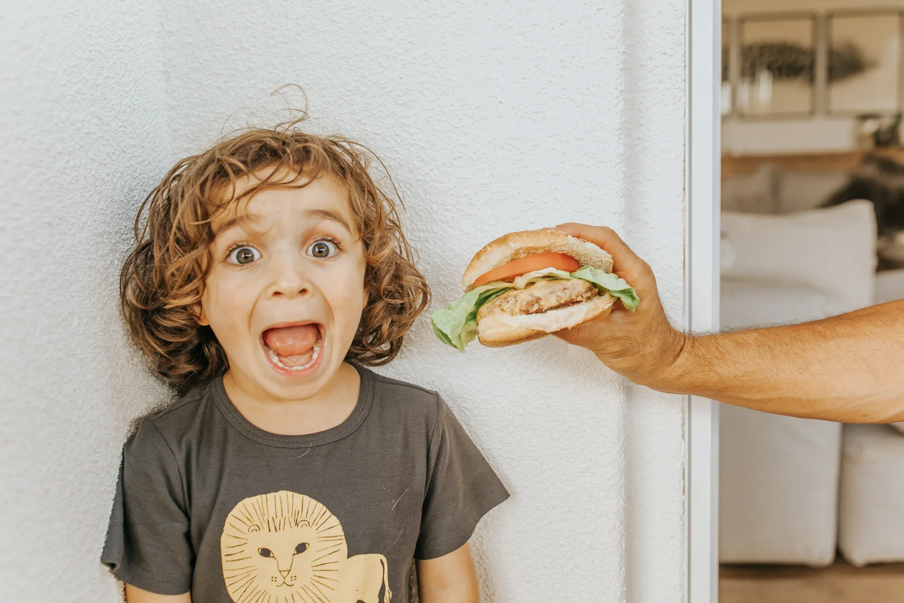 kid with funny face and hamburger