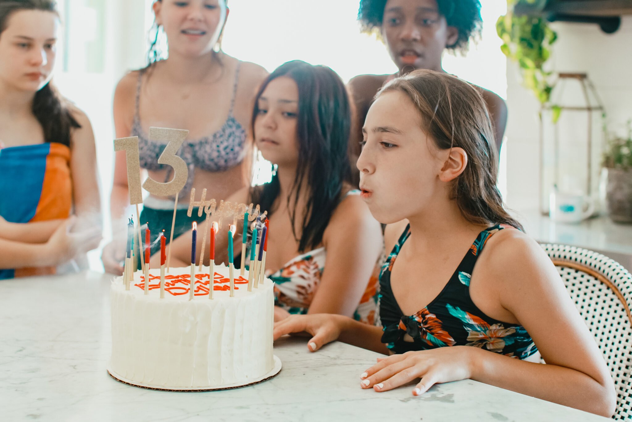 girl blowing out candles