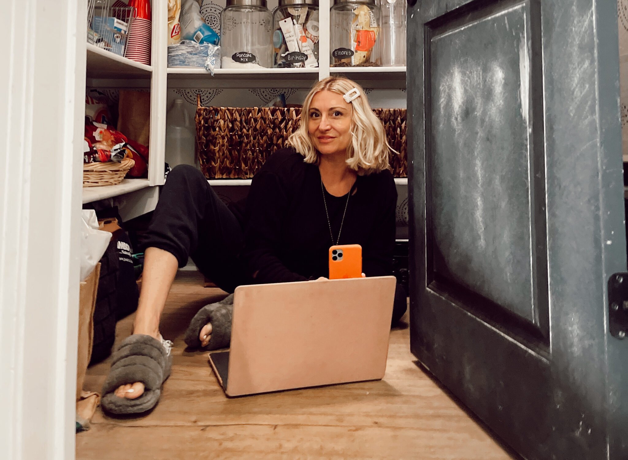 woman in her pantry on her laptop