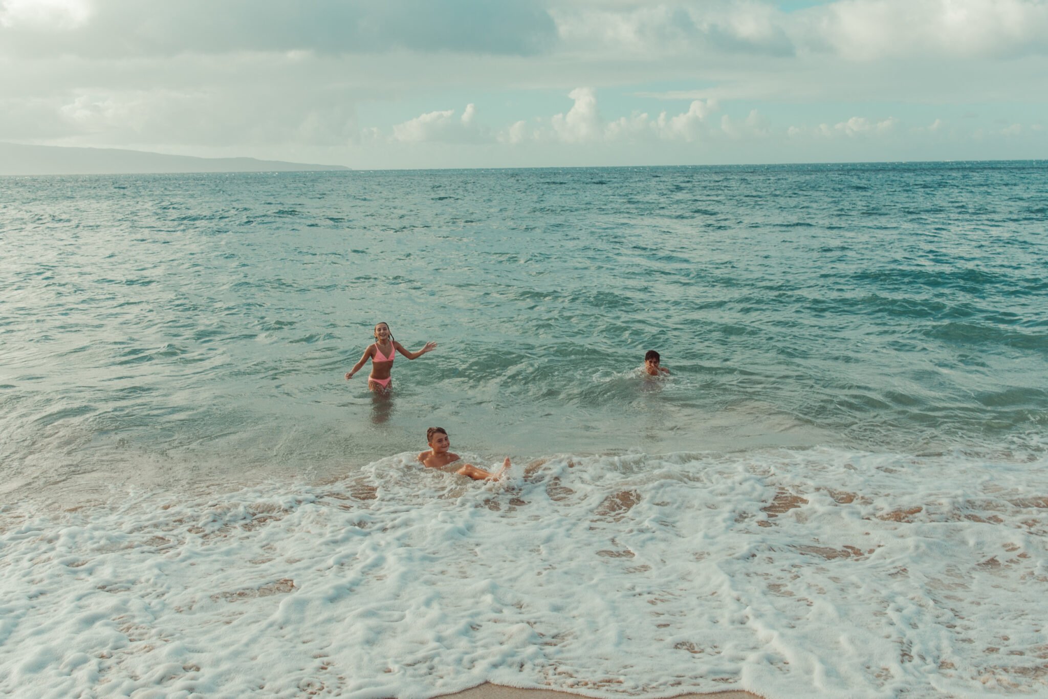 kids playing in the ocean