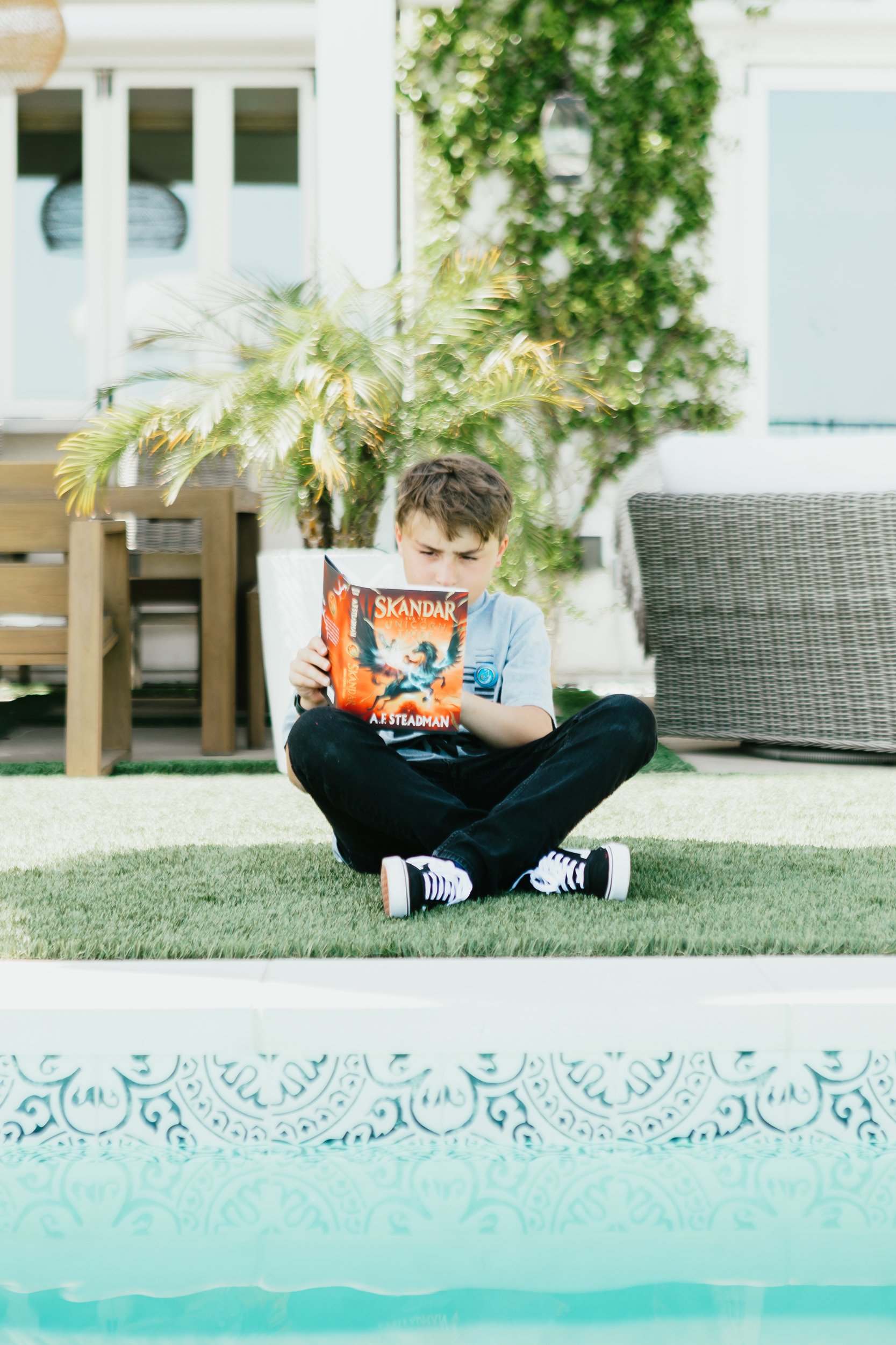 boy reading outside