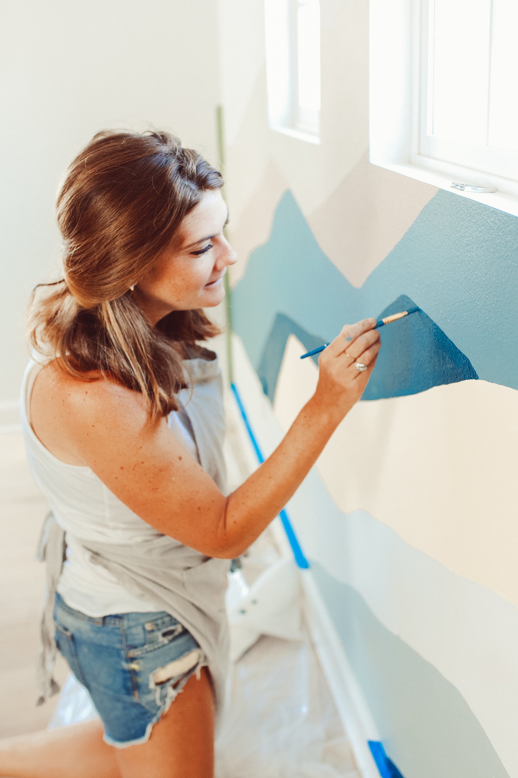 woman painting a wall