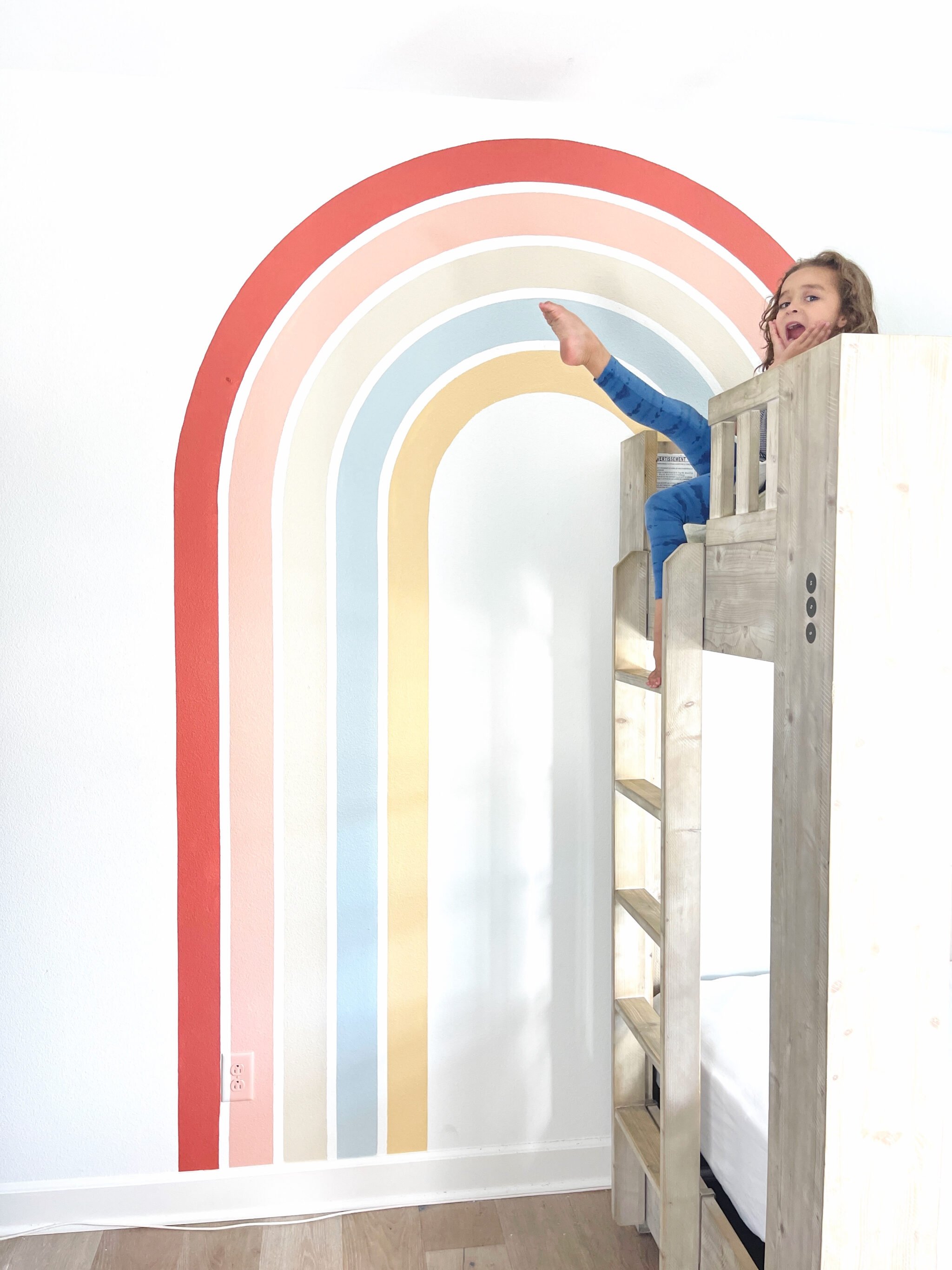 happy kid sitting in bunk bed