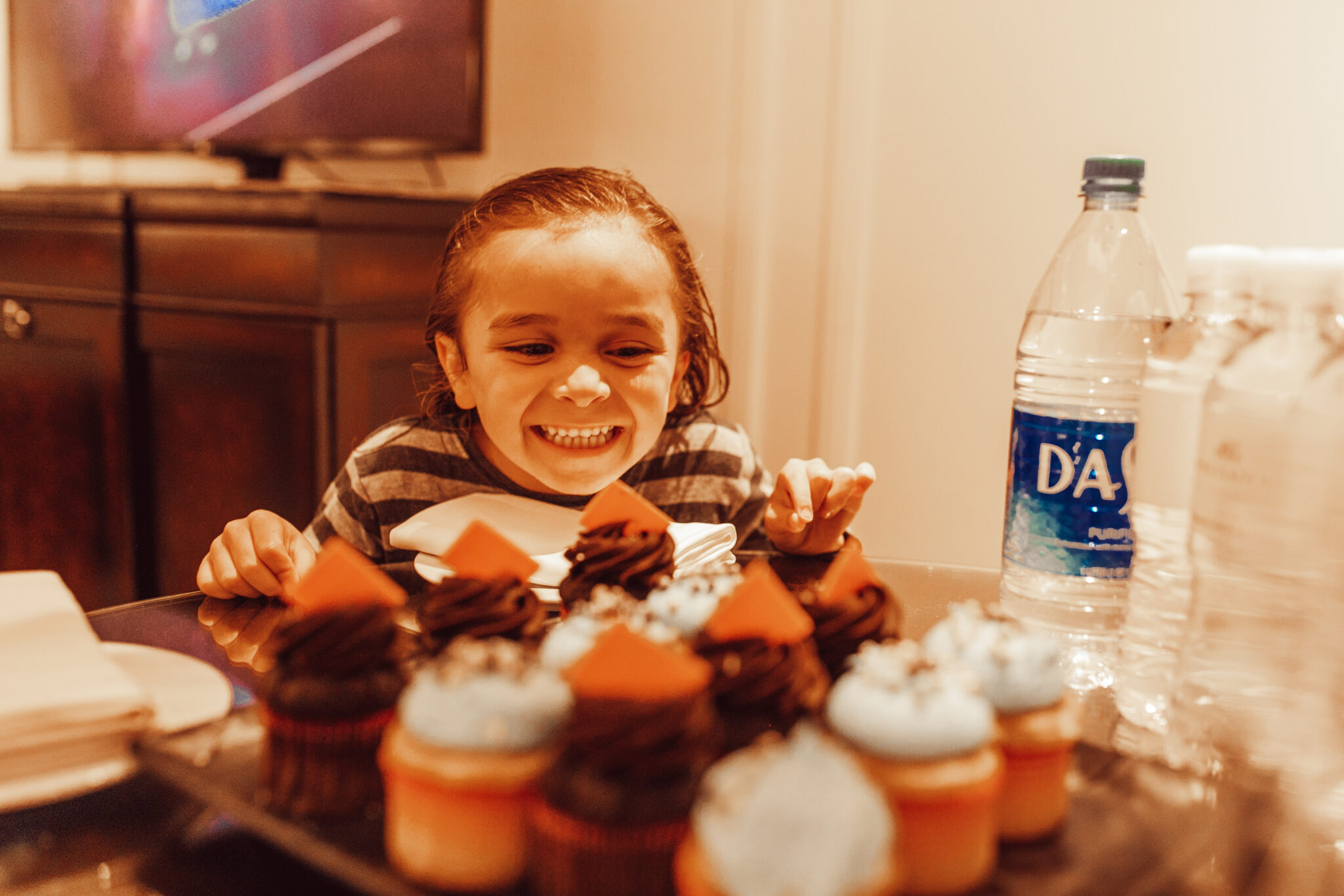 boy looking at cupcakes