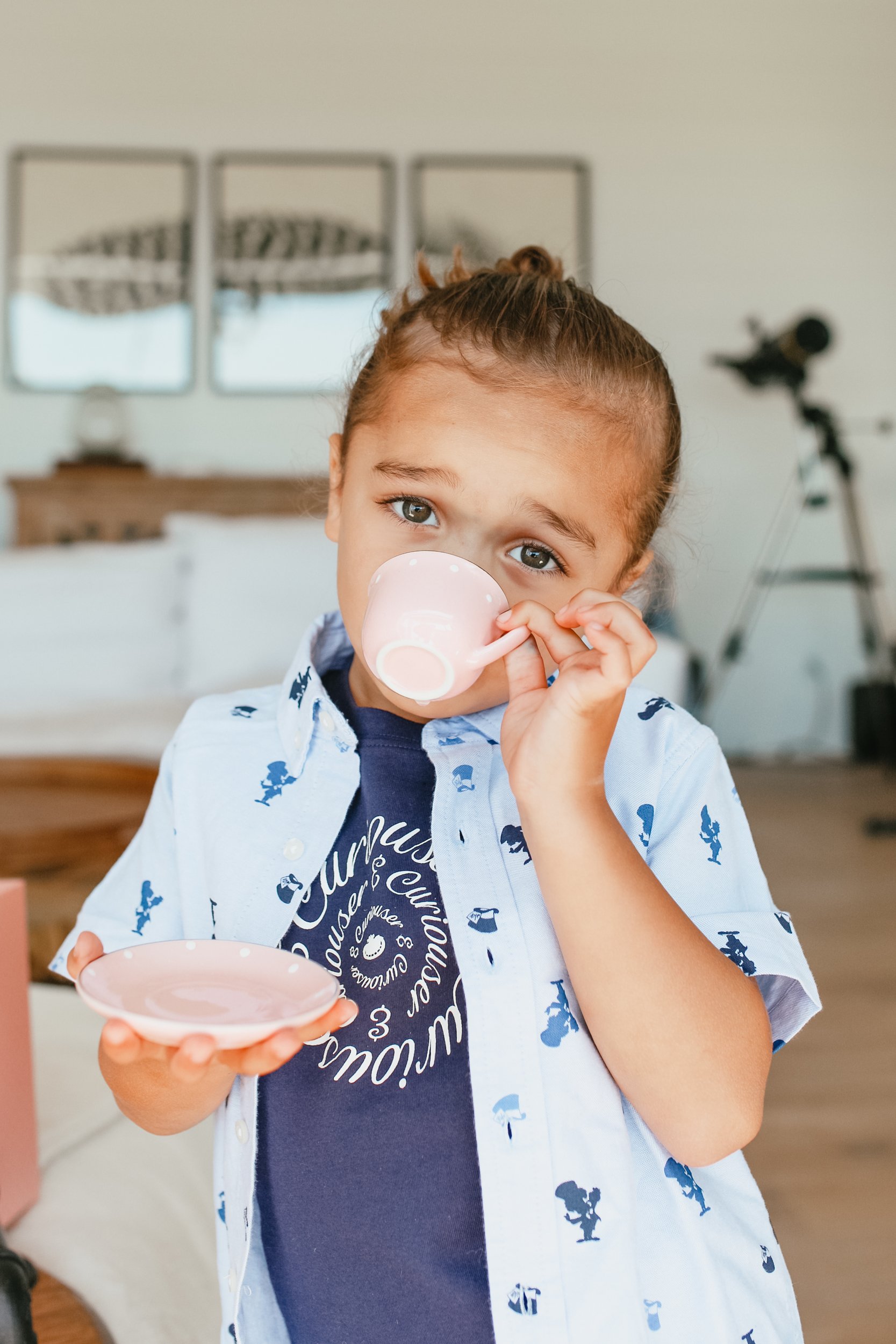 boy sipping from teacup