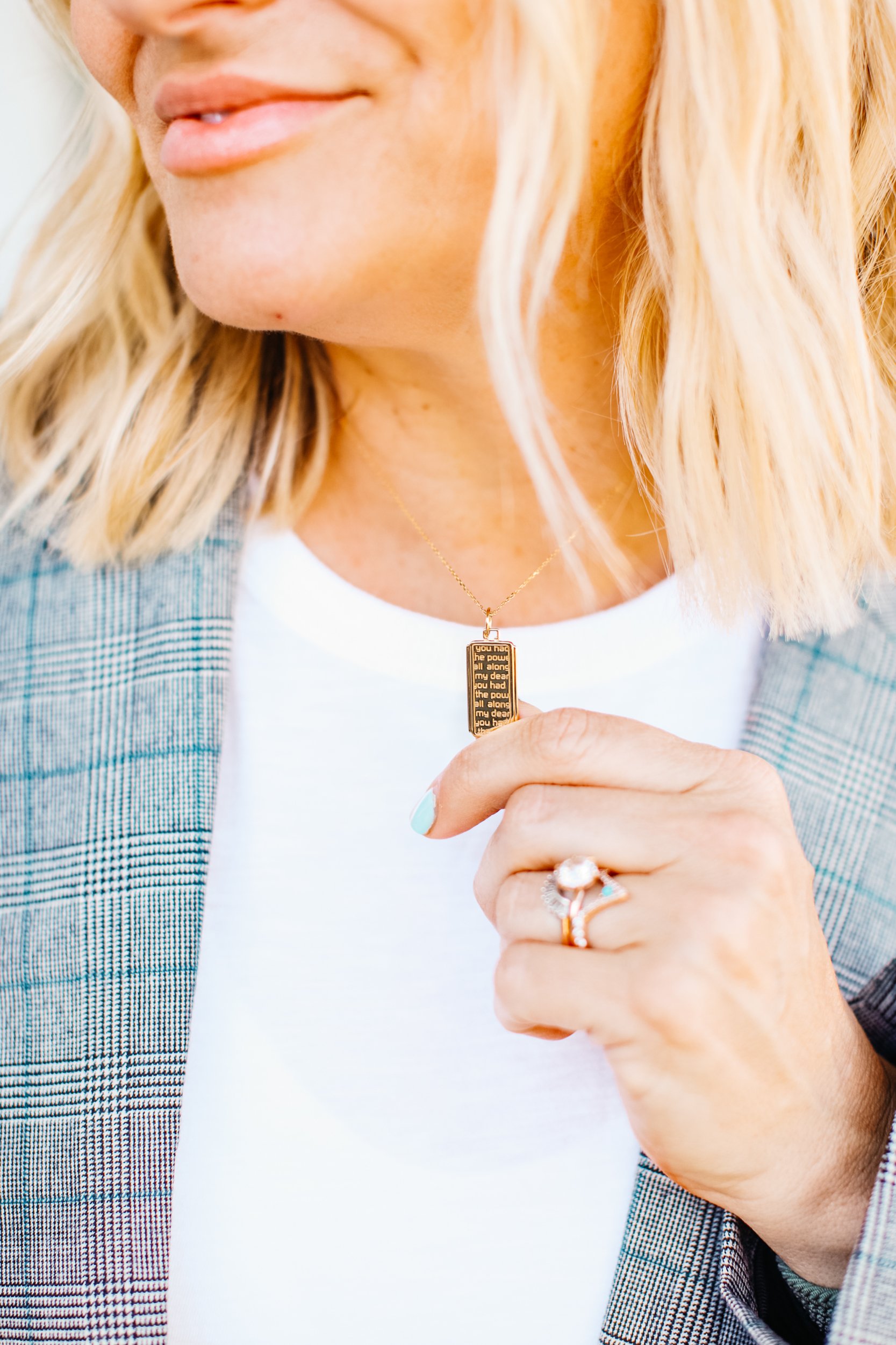 woman holding necklace