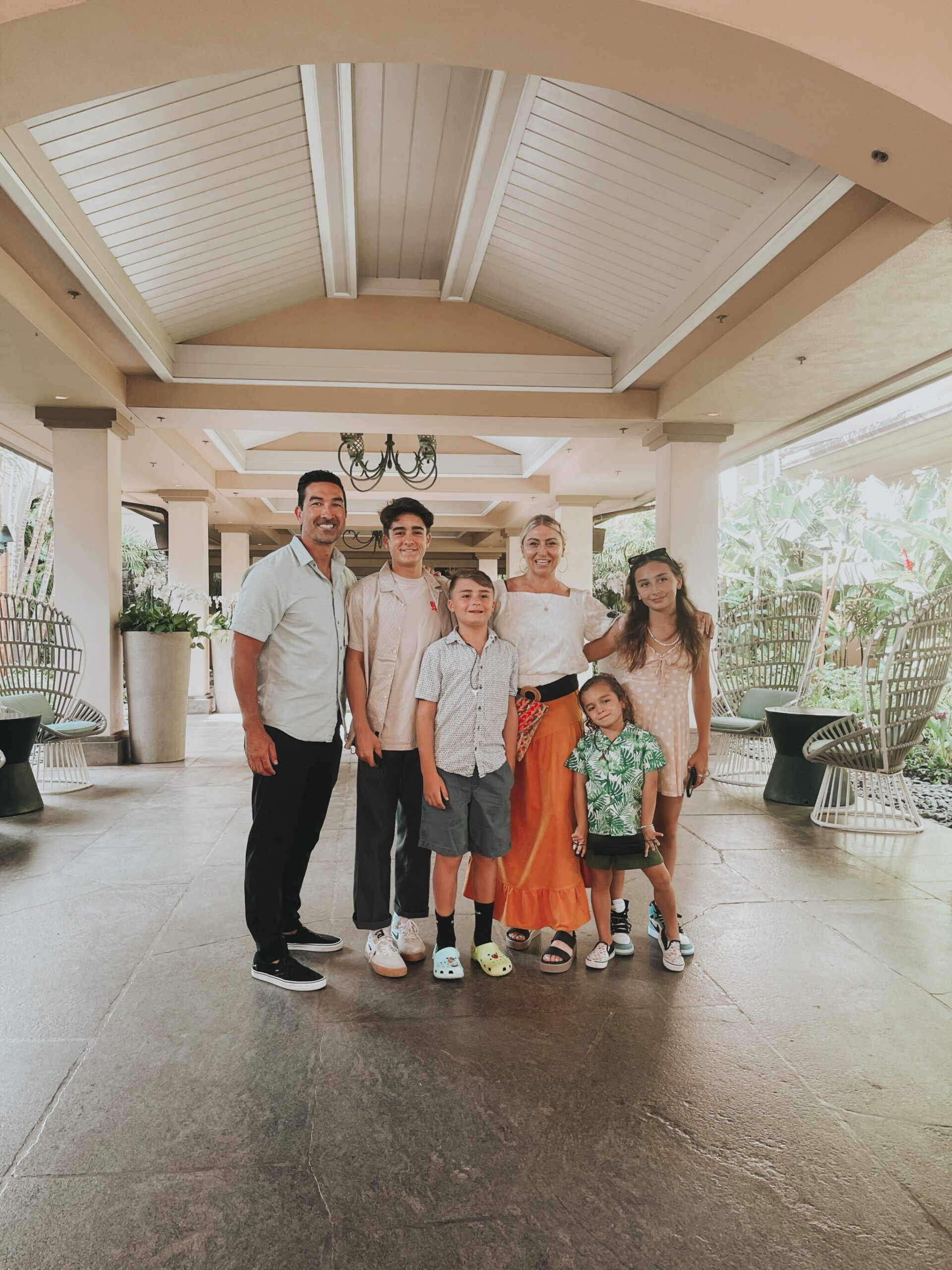 family standing together at entrance to hotel