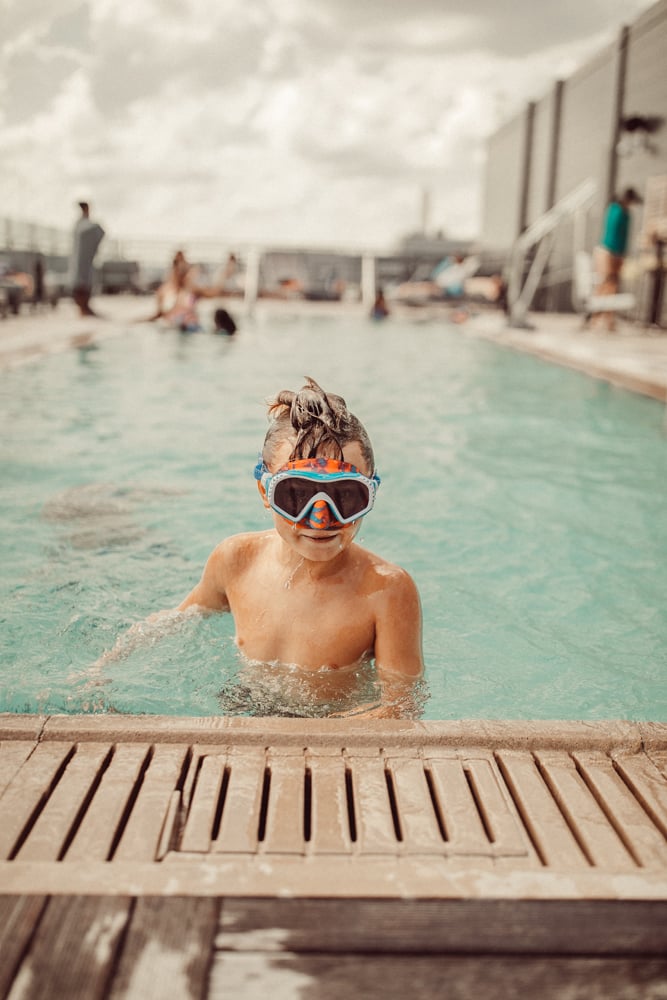 kid in the pool with goggles