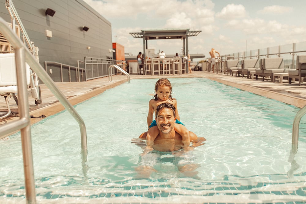 dad and son in pool