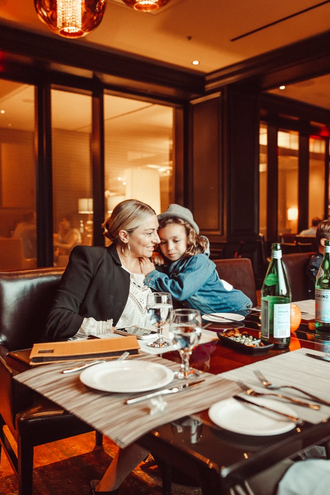 mom hugging son at dining table