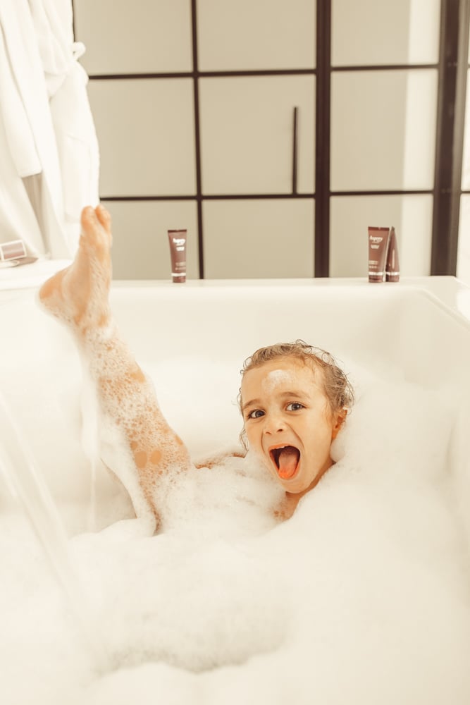 boy playing in bathtub