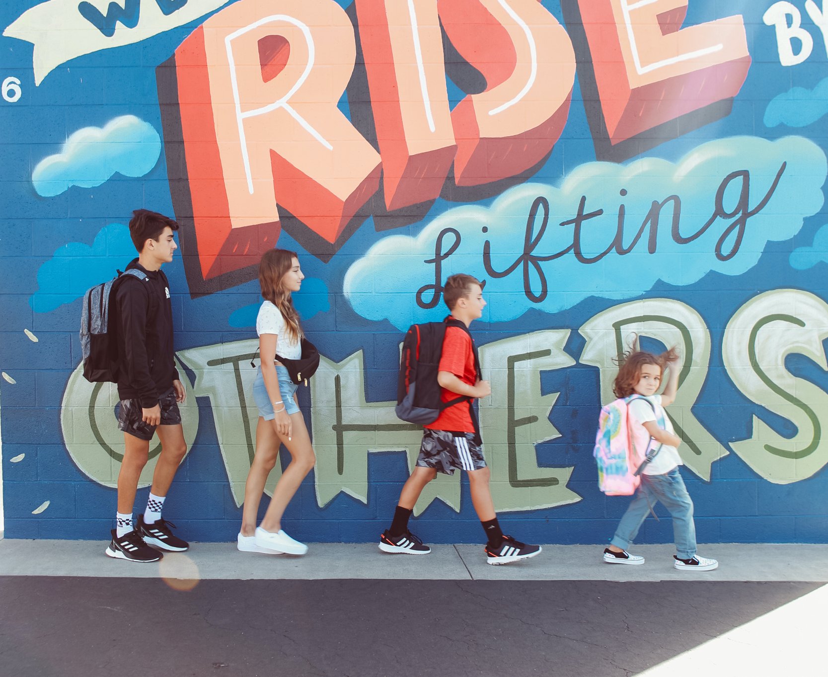 siblings walking in a line