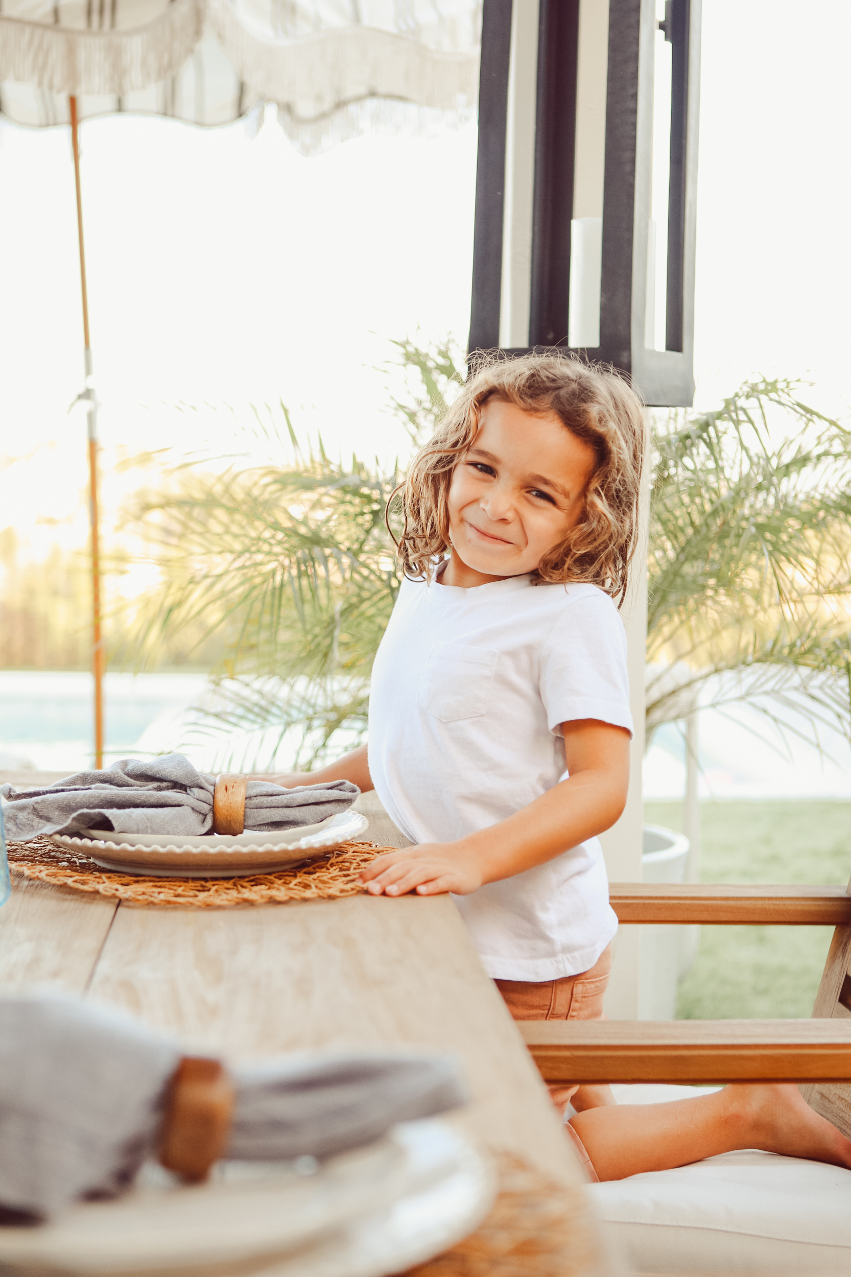 smiling kid at dinner table 