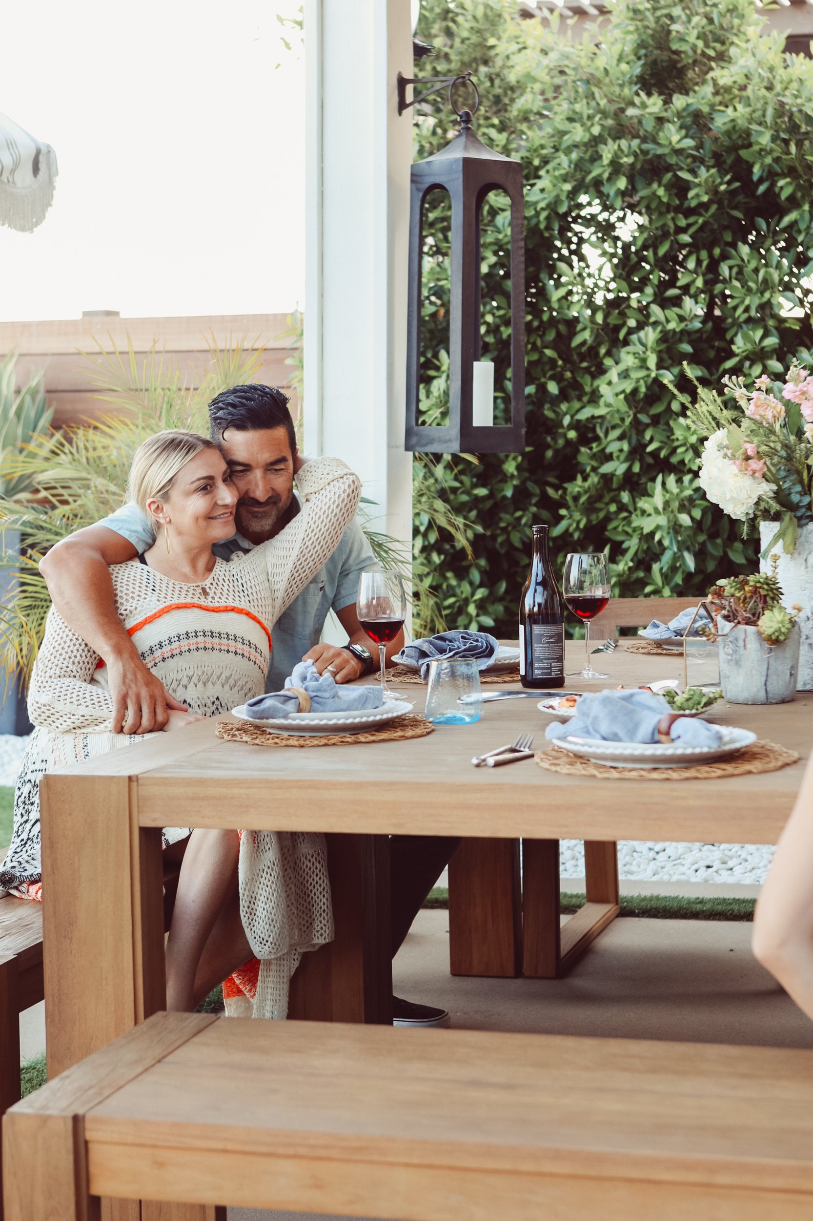 married couple hugging at table