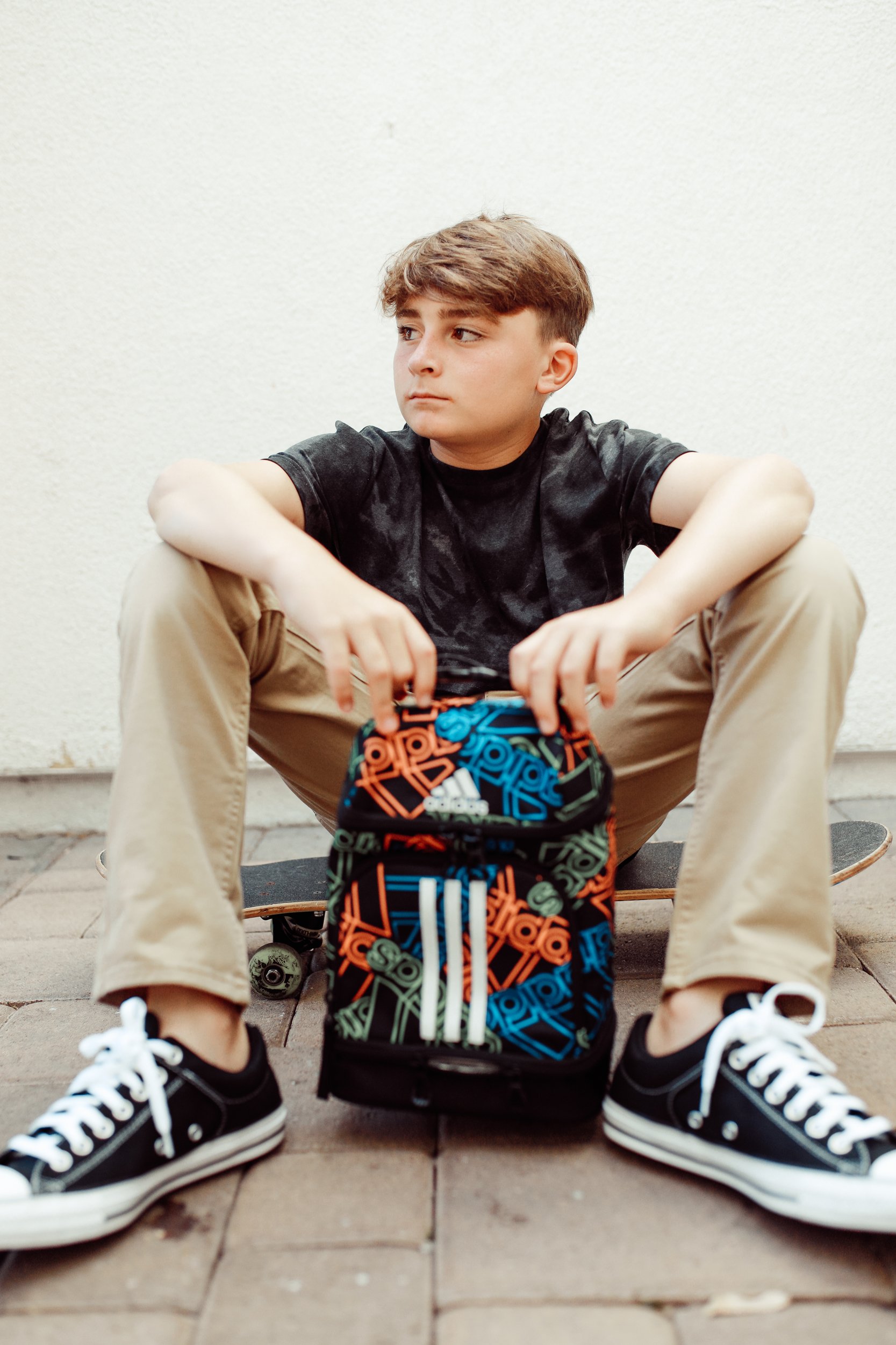 boy sitting on skateboard