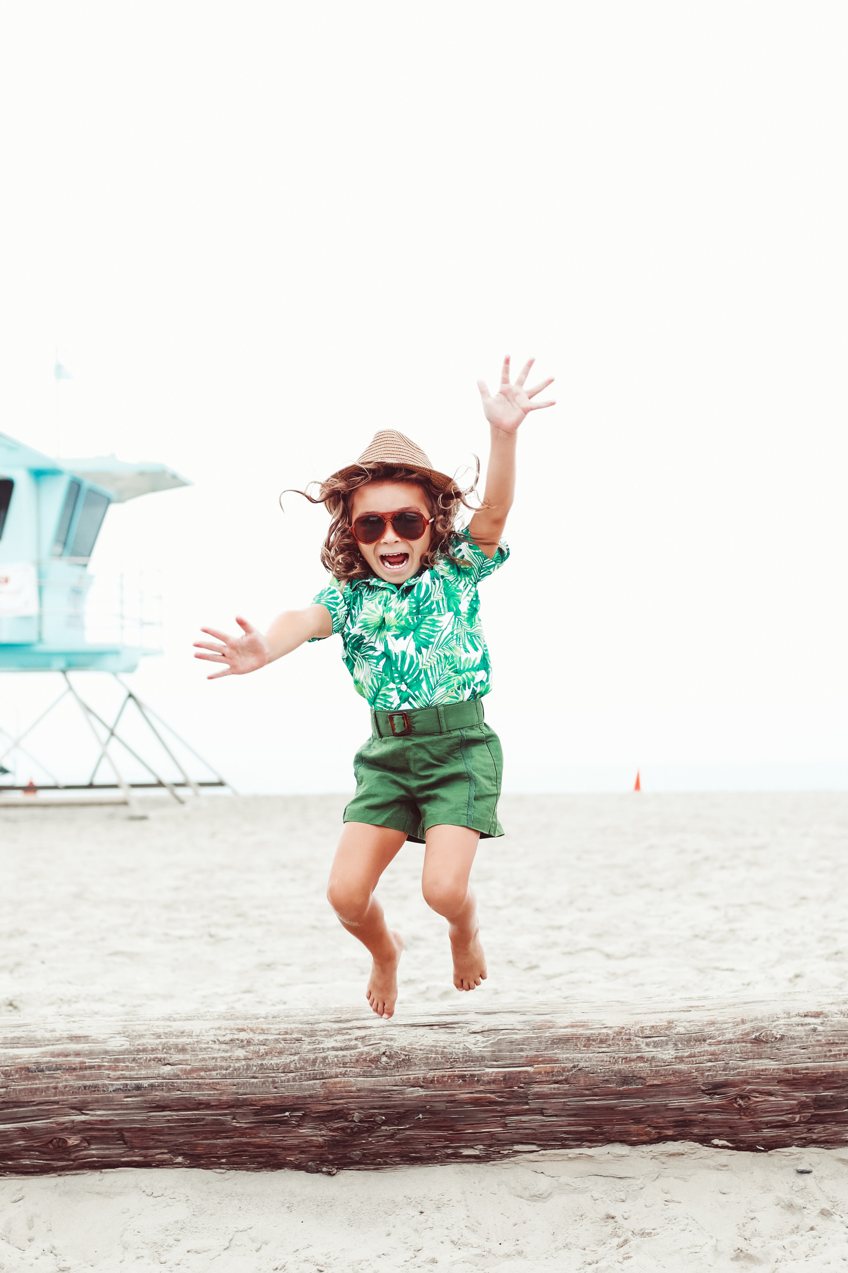 boy jumping in the sand