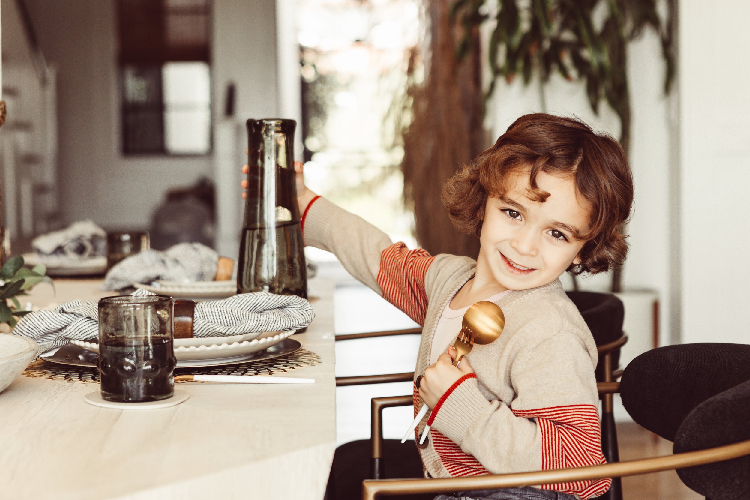 boy sitting at table ready to eat