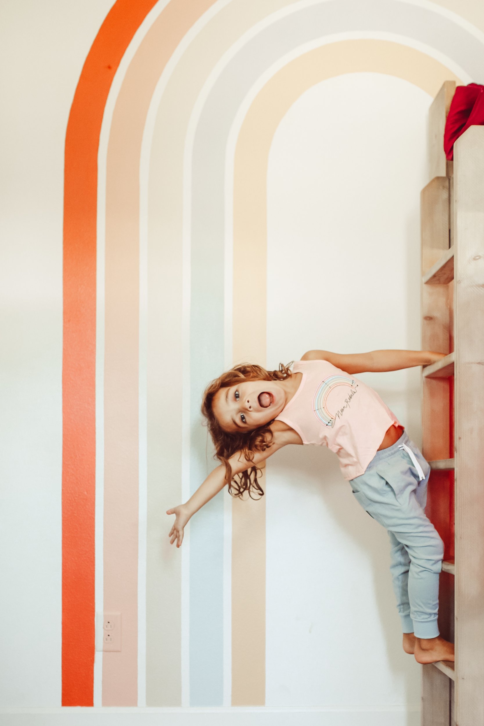 boy hanging off ladder