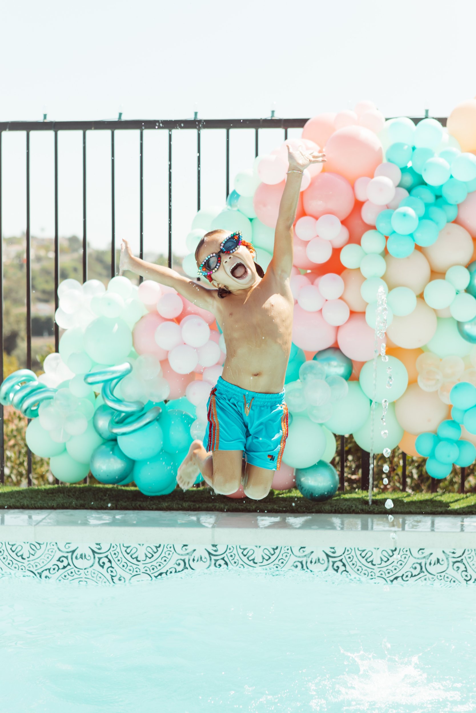 boy jumping in a pool