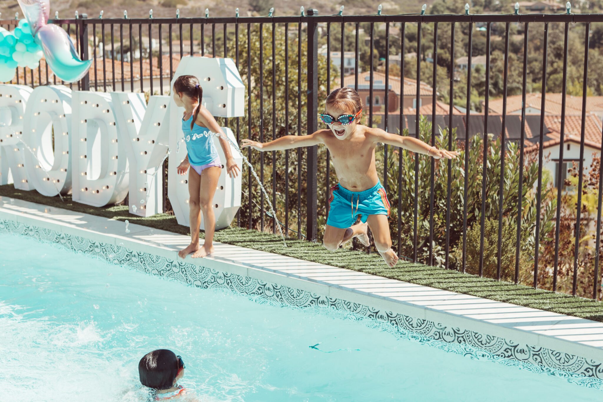 boy jumping in the pool