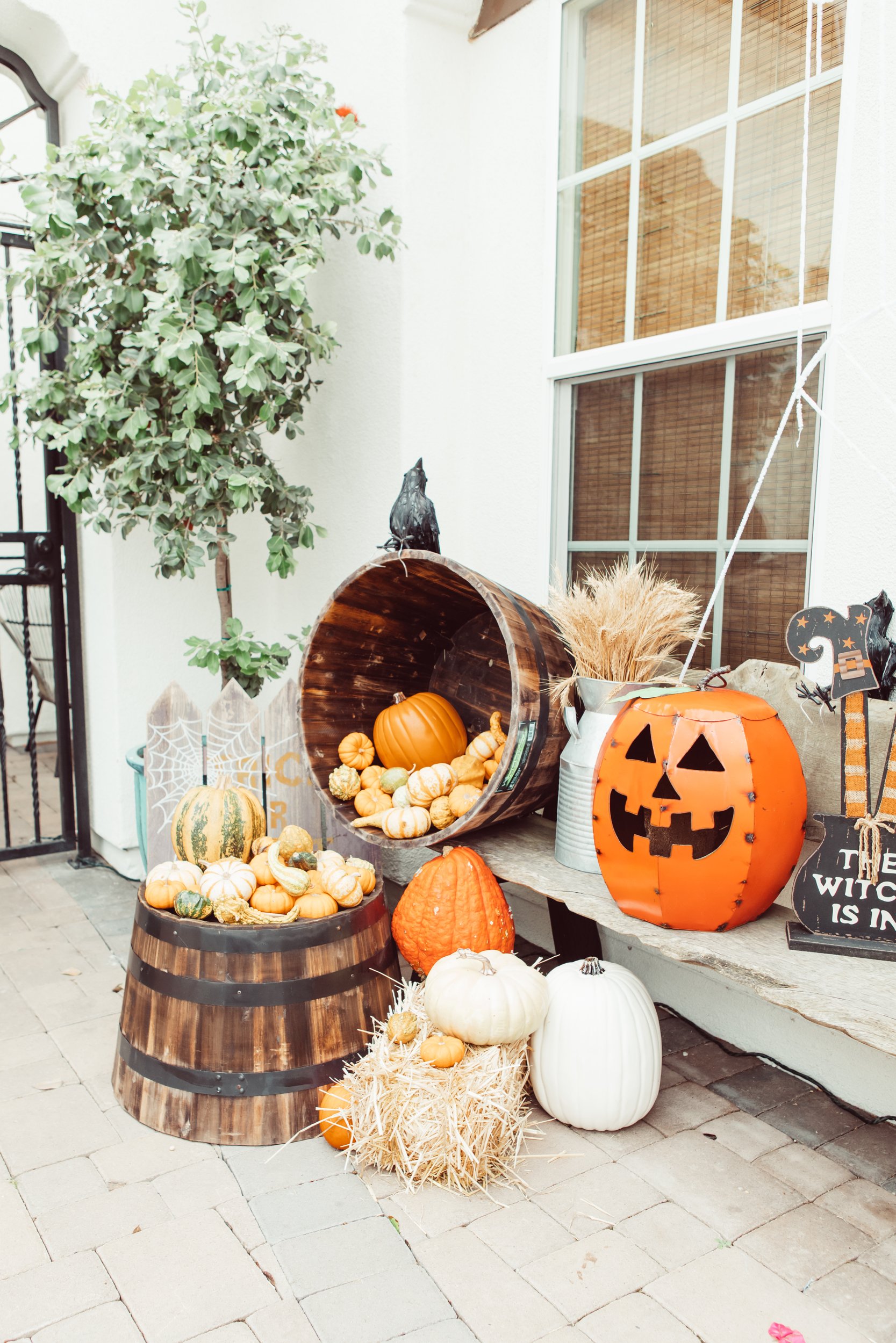 pumpkins and halloween decor on a porch