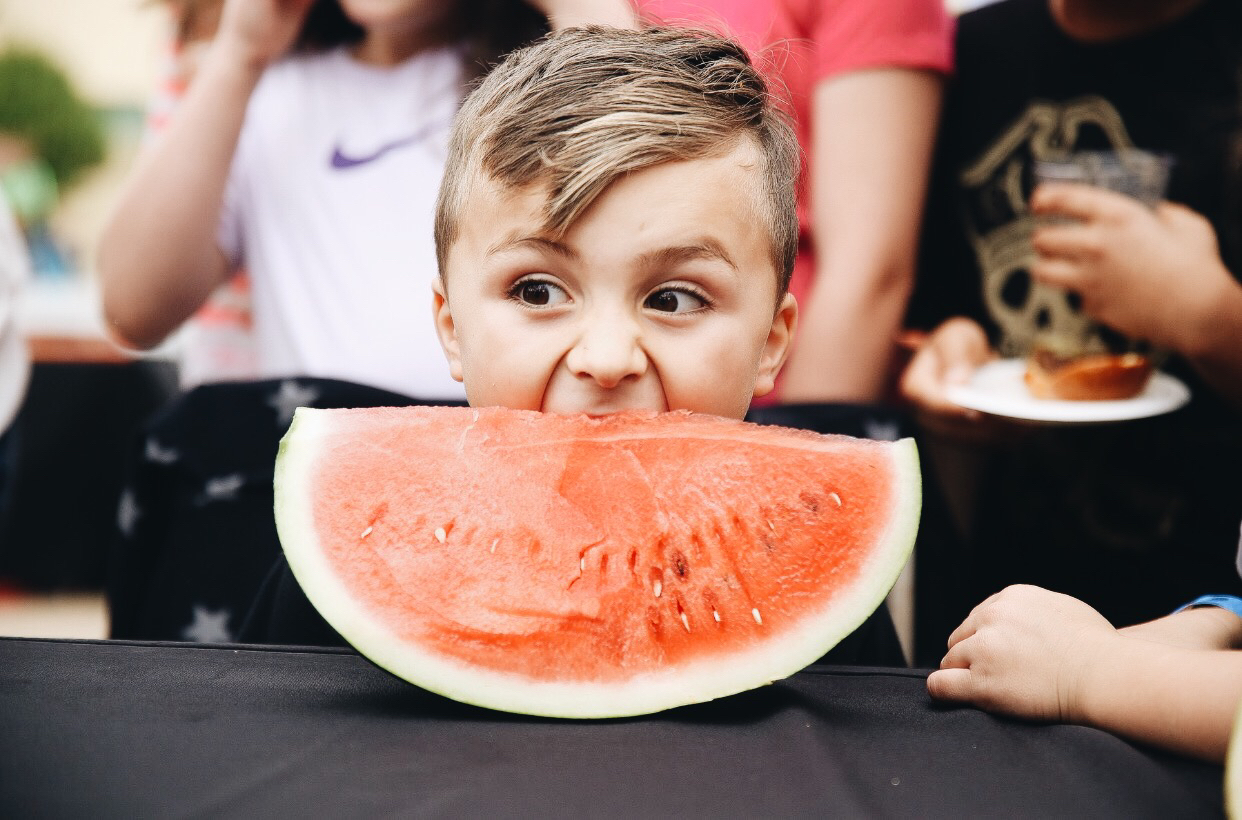 boy eating a watermelon