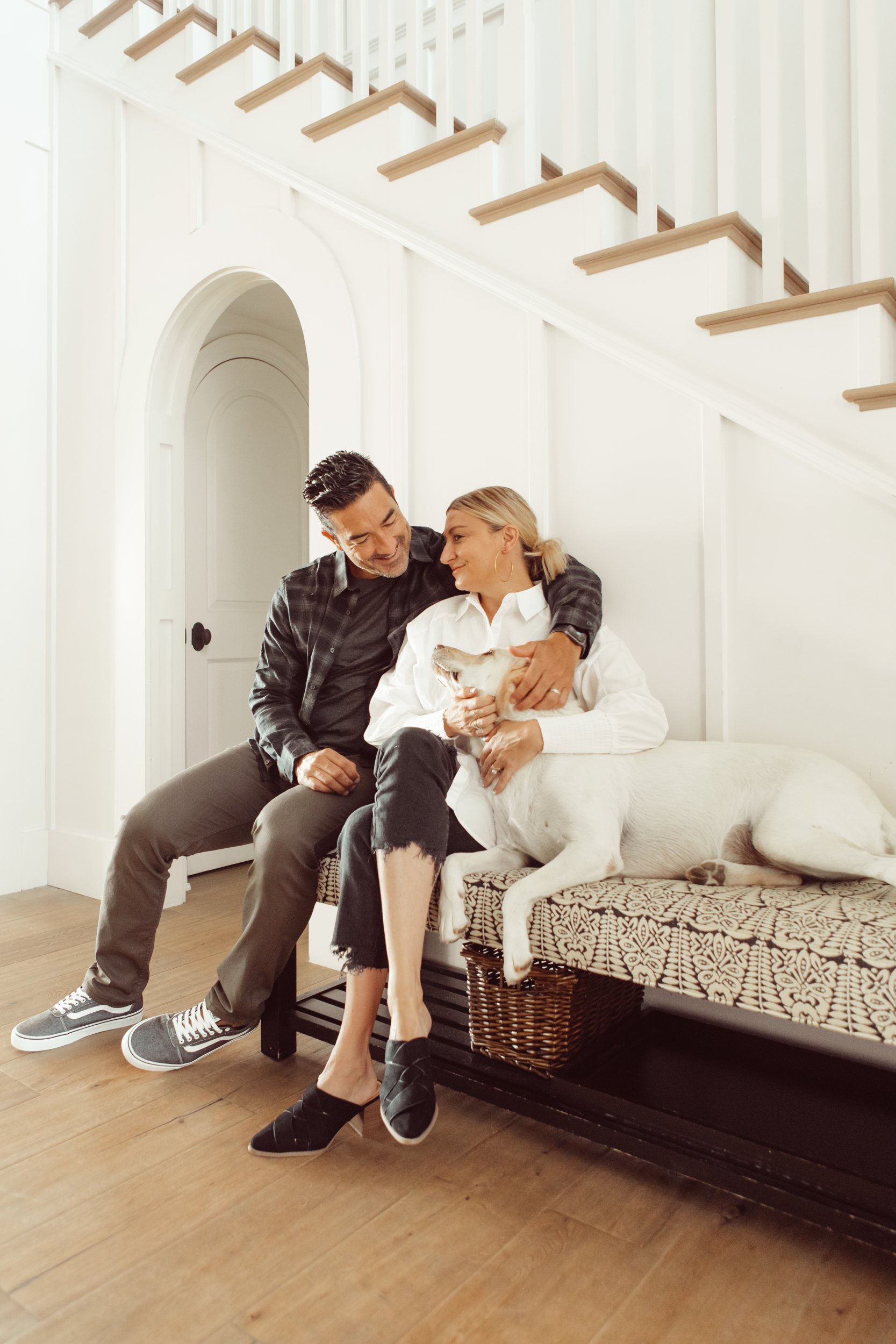 couple cuddling with their dog