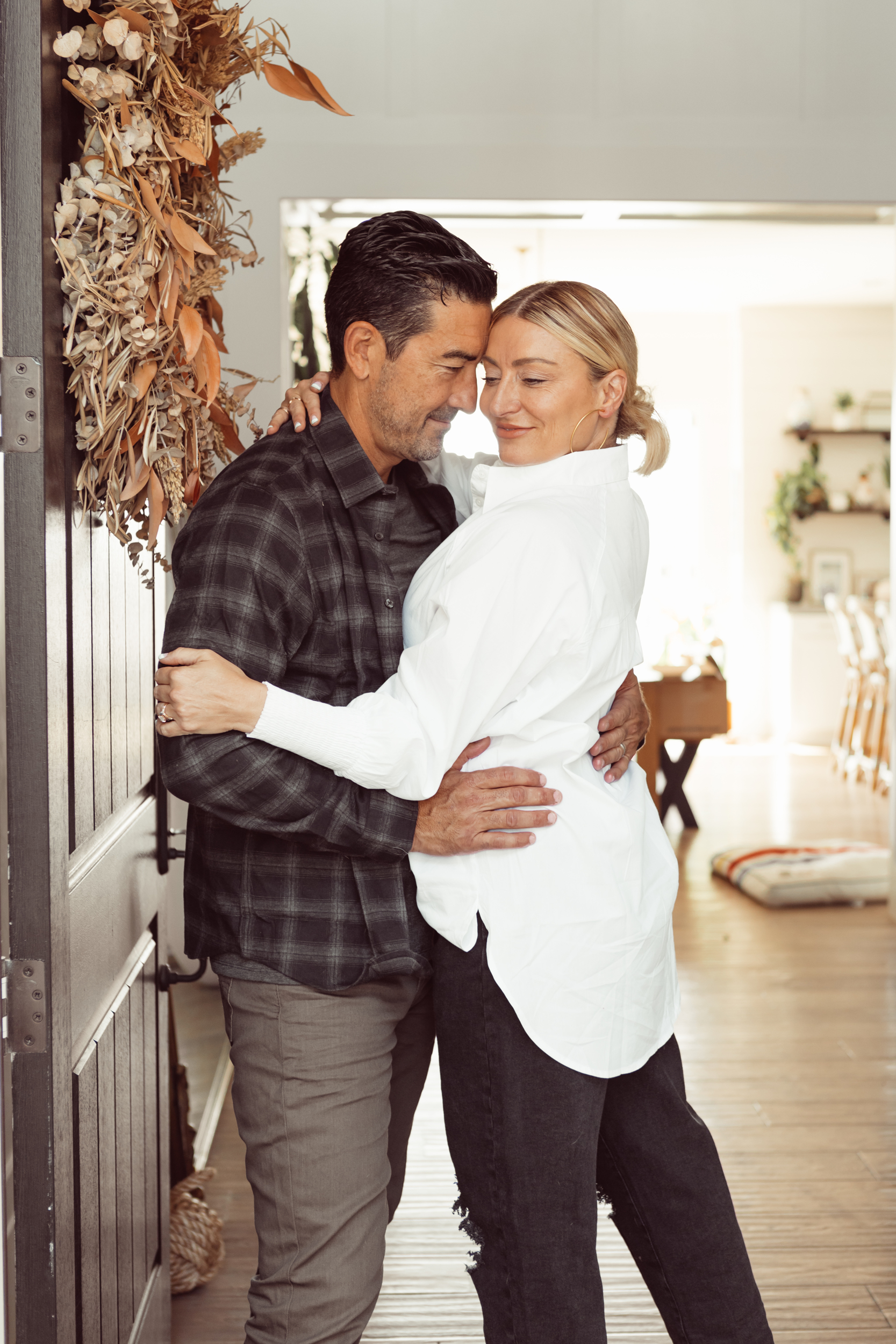 couple hugging by door