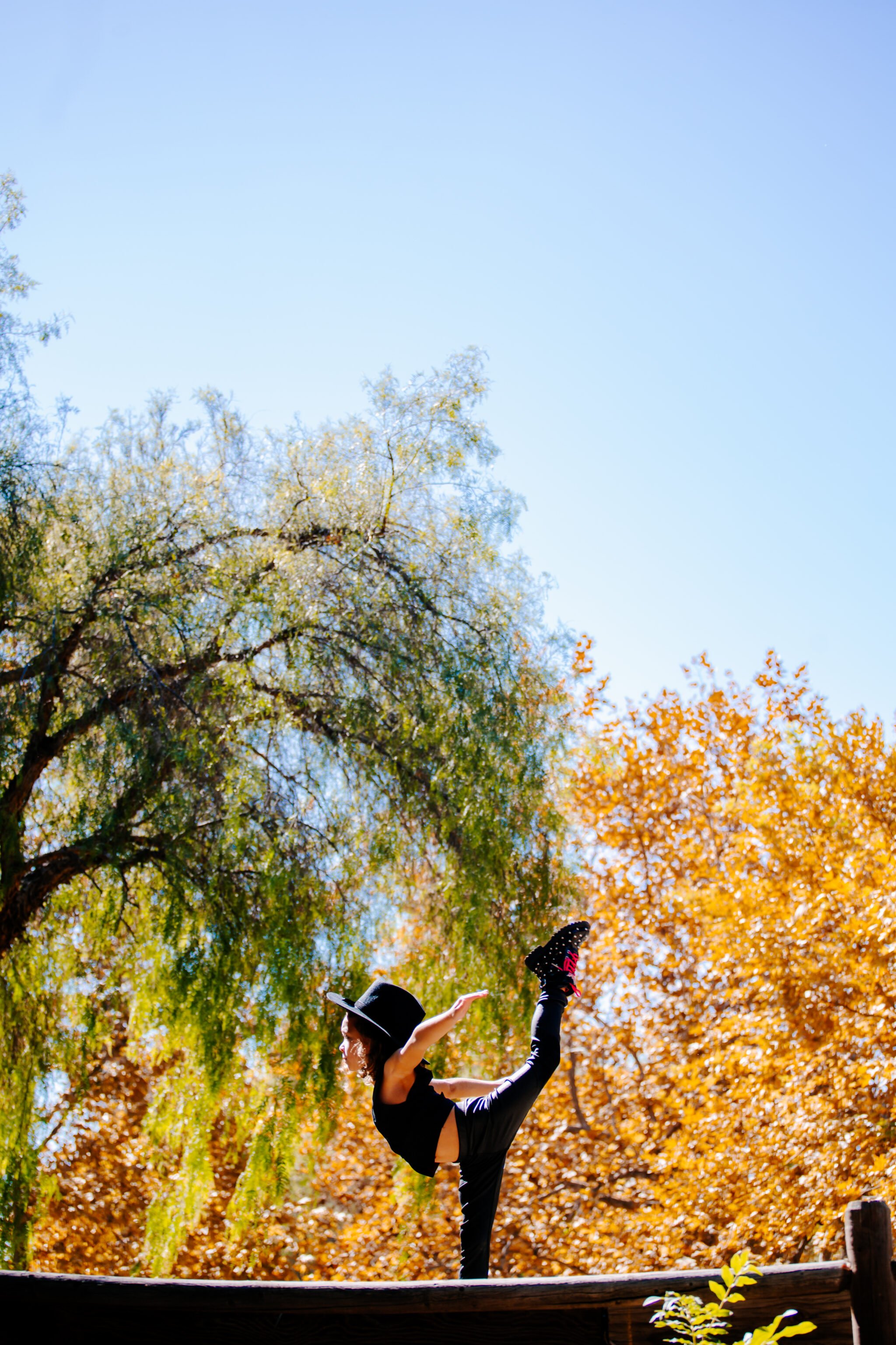 boy dancing in fall trees